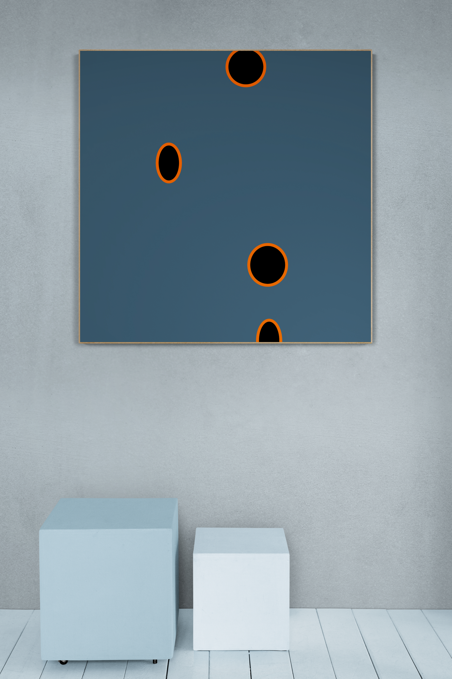 Abstract art piece print with black circles on a blue background in a minimalistic room.
