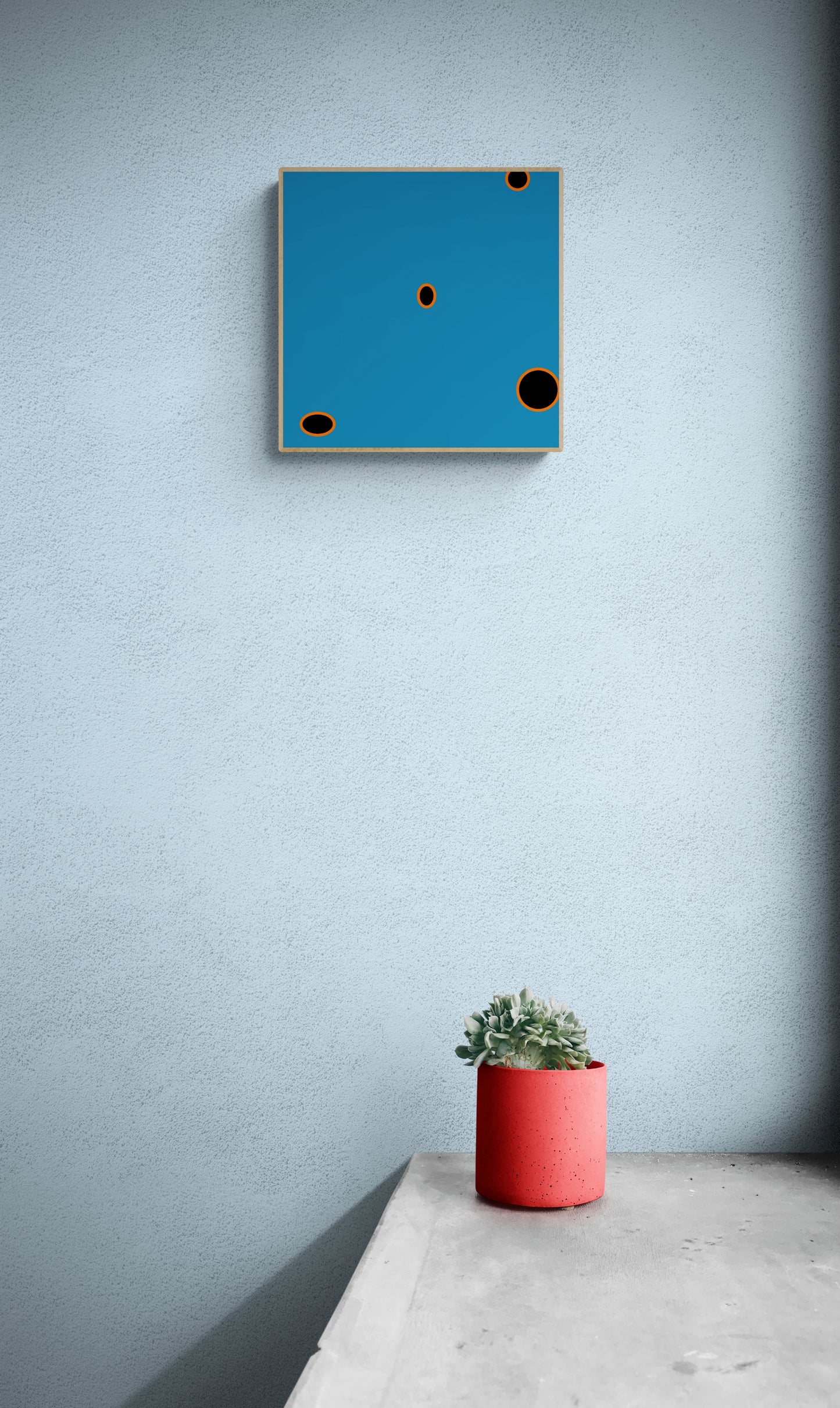 Blue abstract art print on a light gray wall with a red pot and plant below.