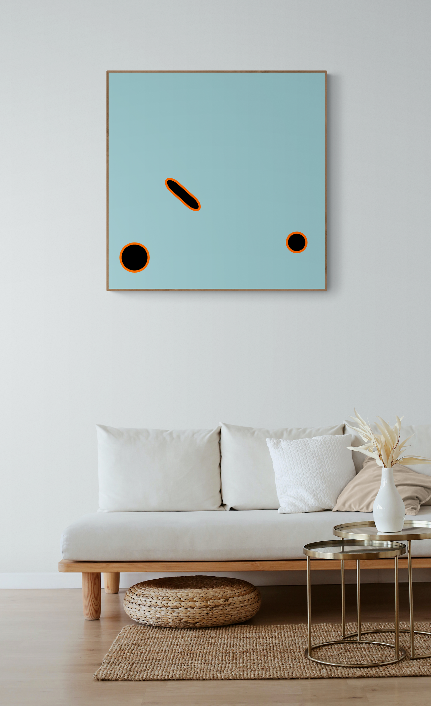 Abstract art print on a wall above a sofa in a living room.