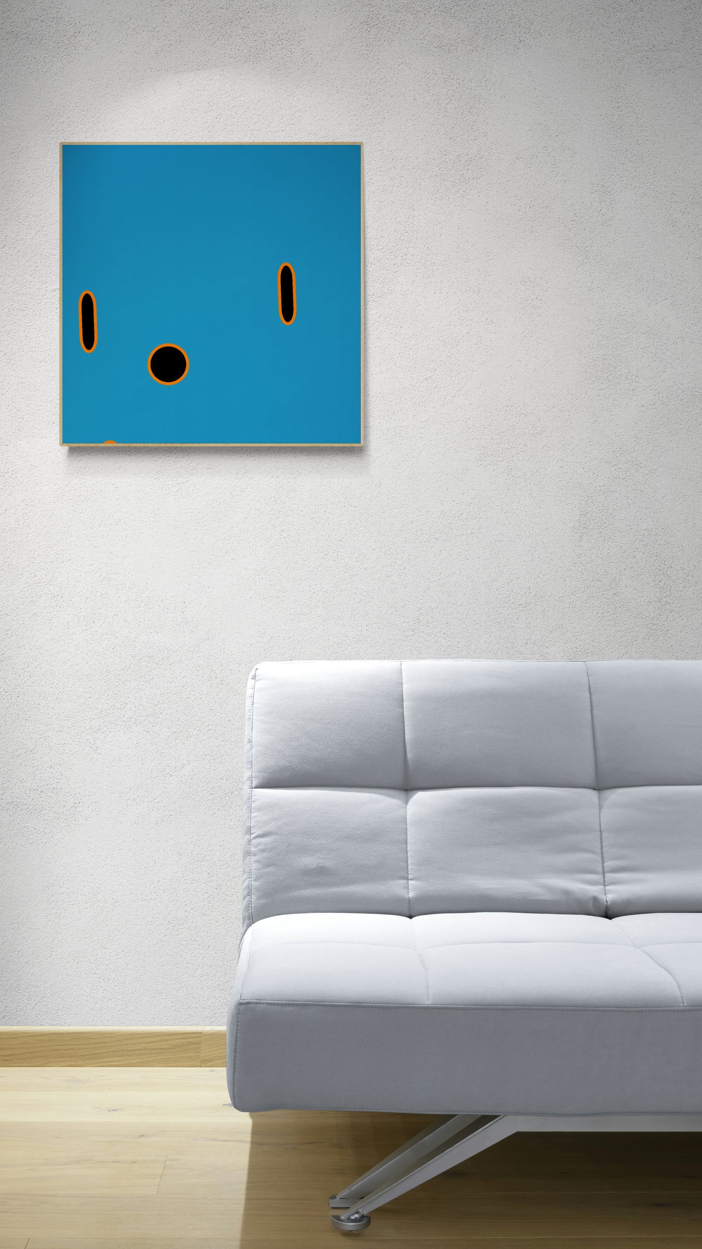 Abstract blue print with black circles on a wall above a gray sofa.