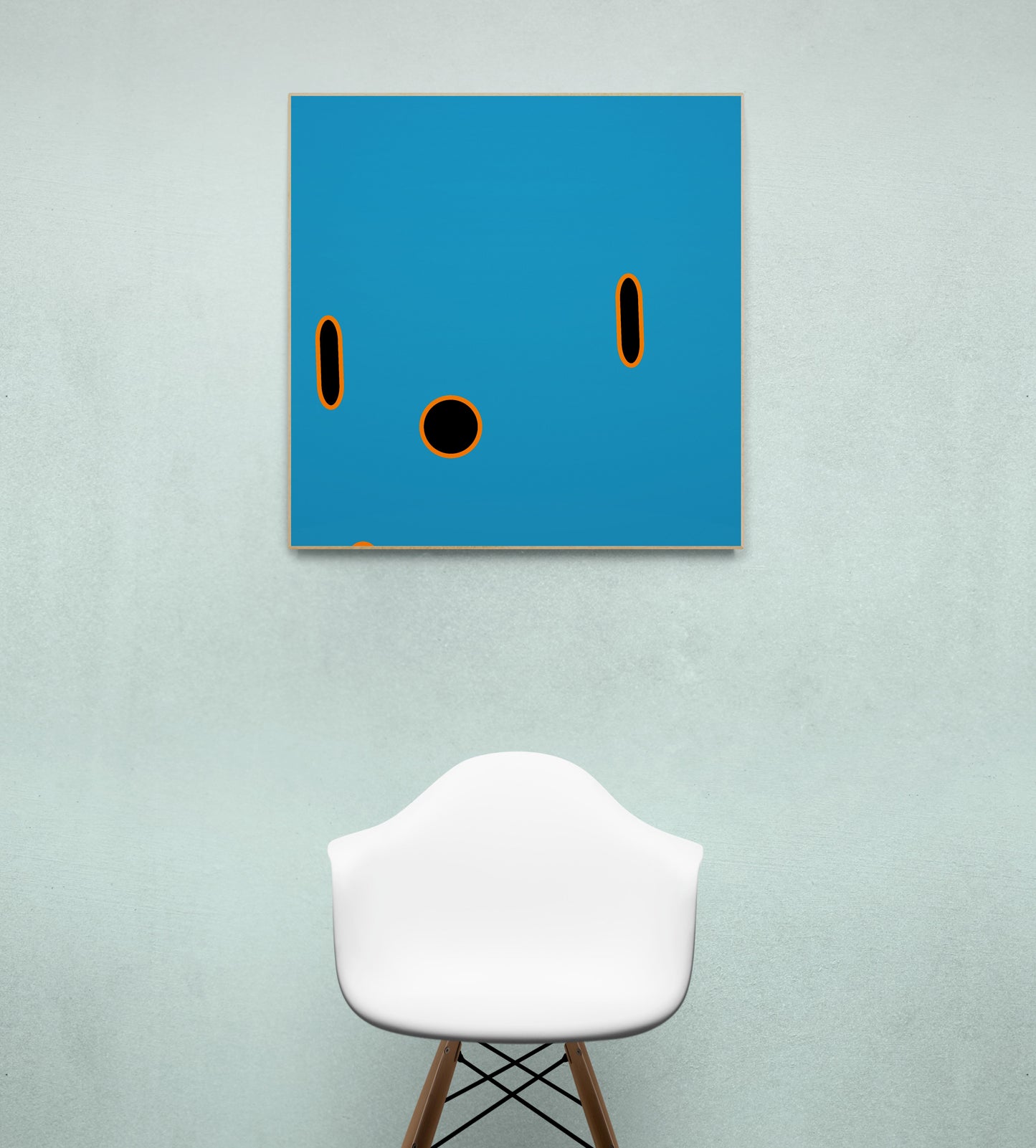 Abstract blue print with black circles on a wall above a white stool.