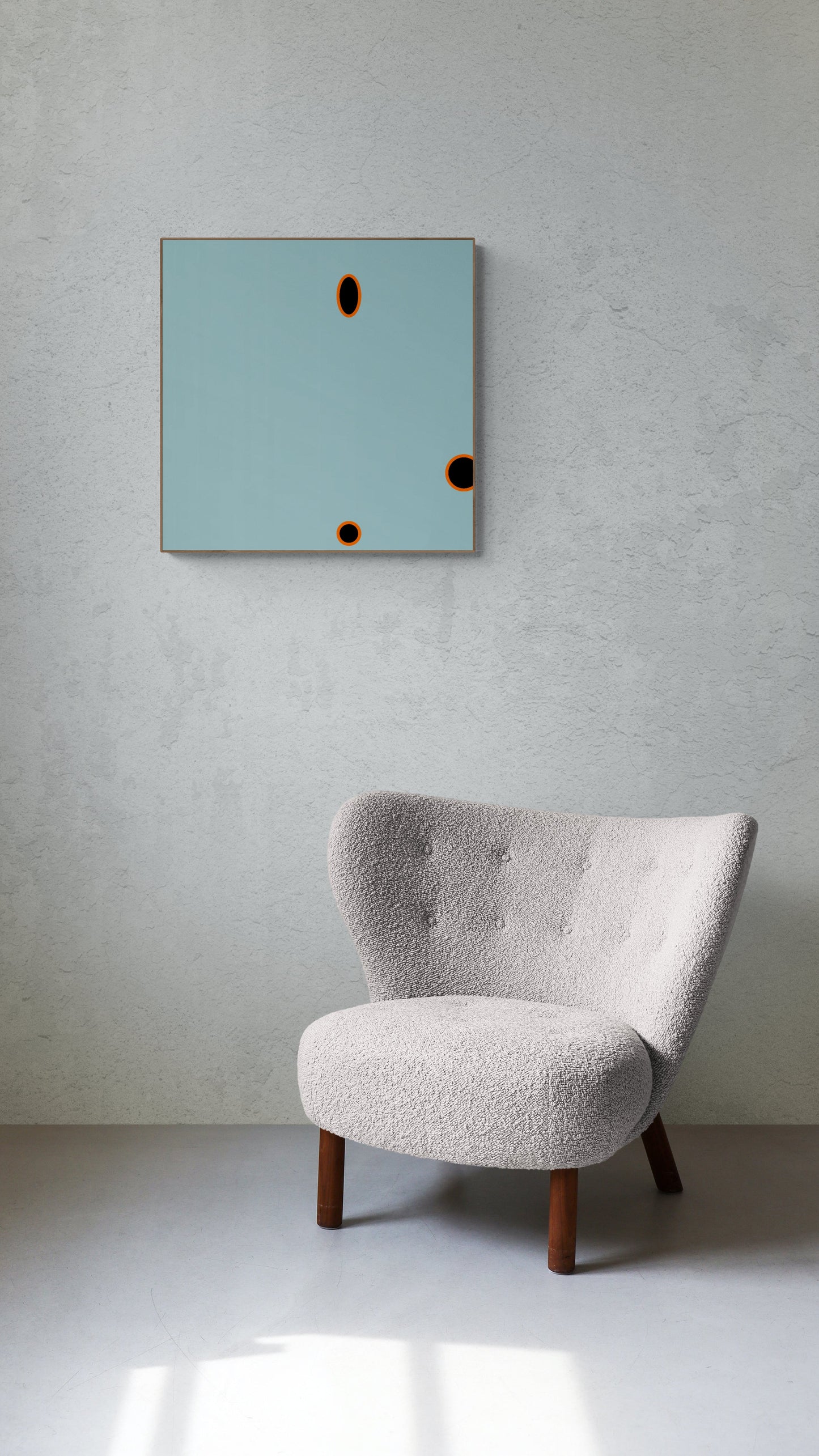Gray armchair in a minimalistic room with a light gray wall and a blue abstract wall art print.