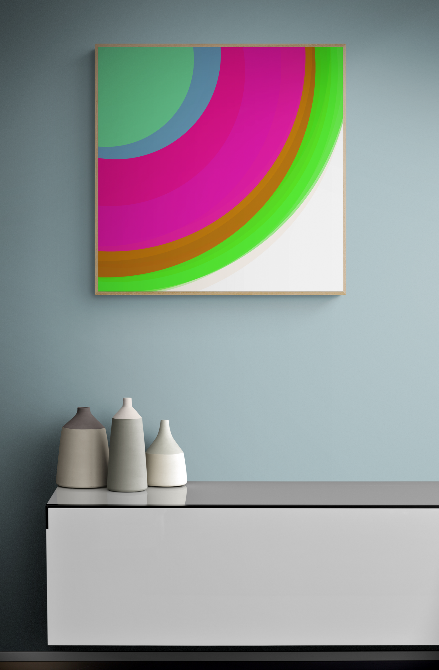 Art print of colorful circular sphere objects on a white background on a wall above a white console table with decorative vases.