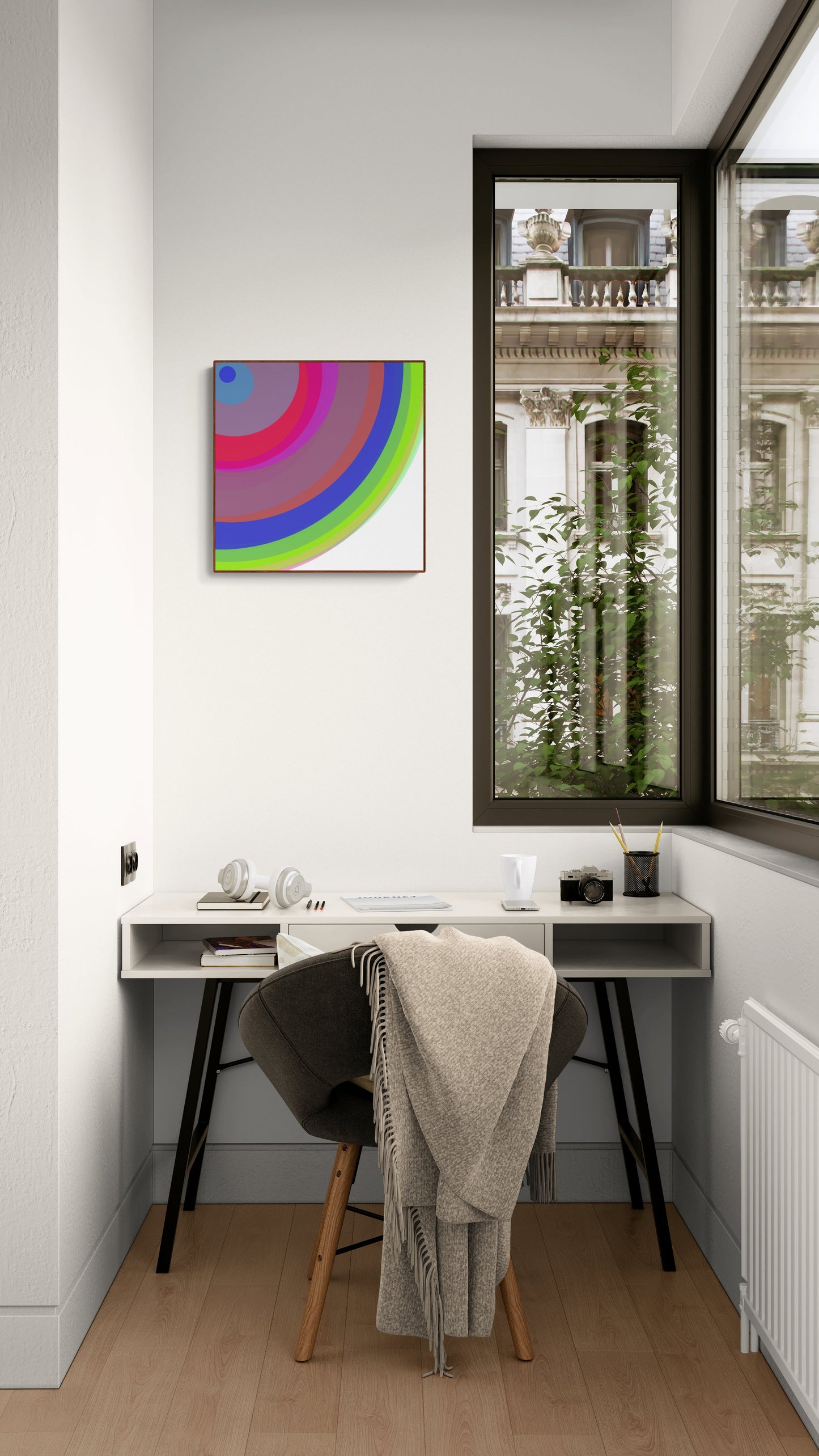 Modern home office with a desk, chair, and colorful abstract aart print on the wall.