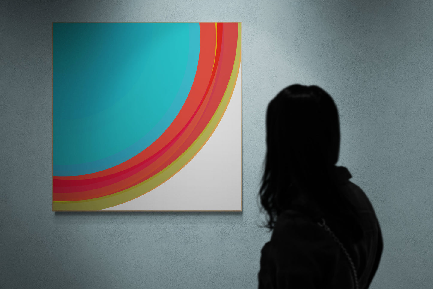Person looking at a colorful abstract art print on a wall