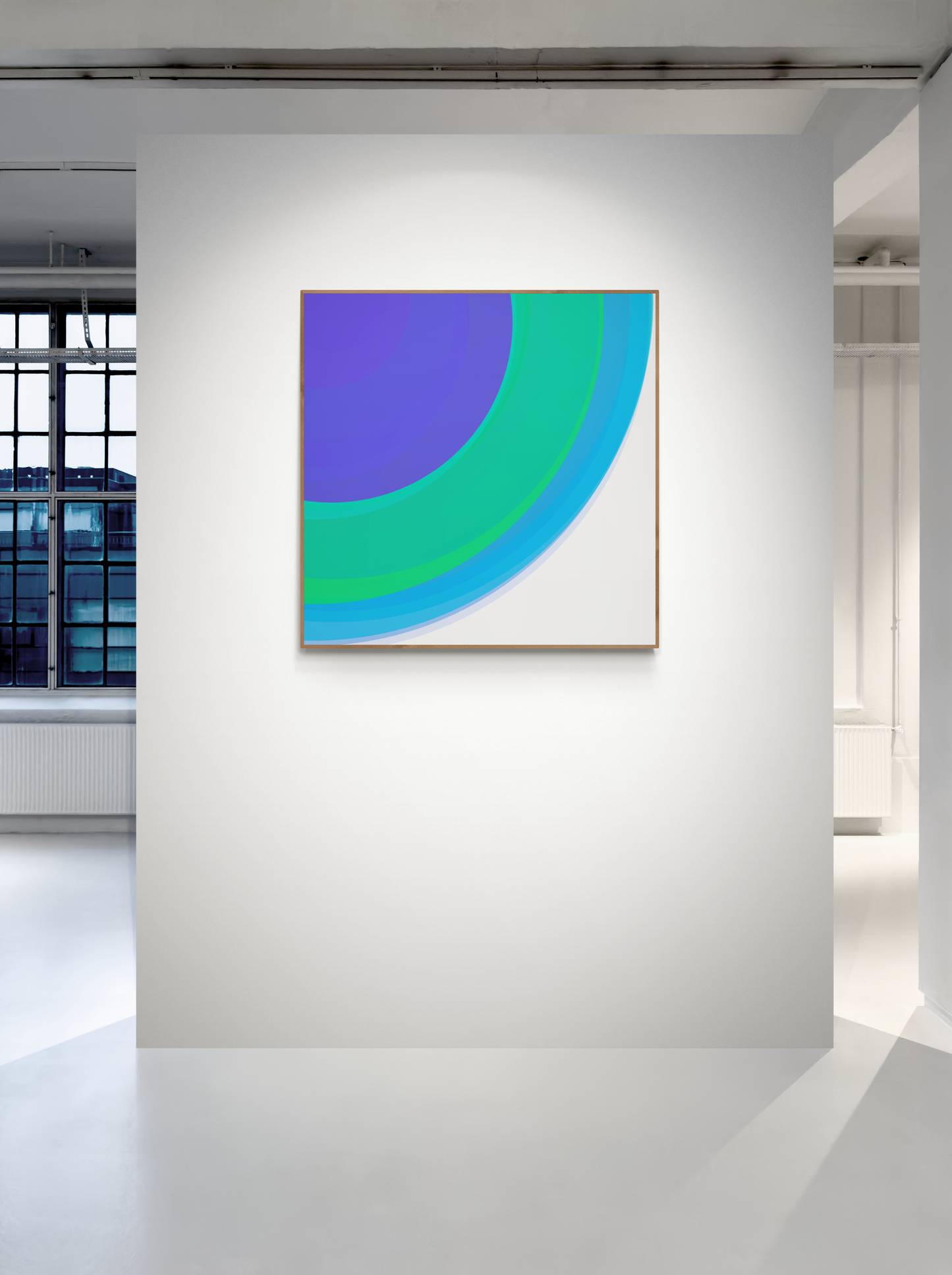 Art print of three concentric circles in blue, green, and purple on a white gallery wall.