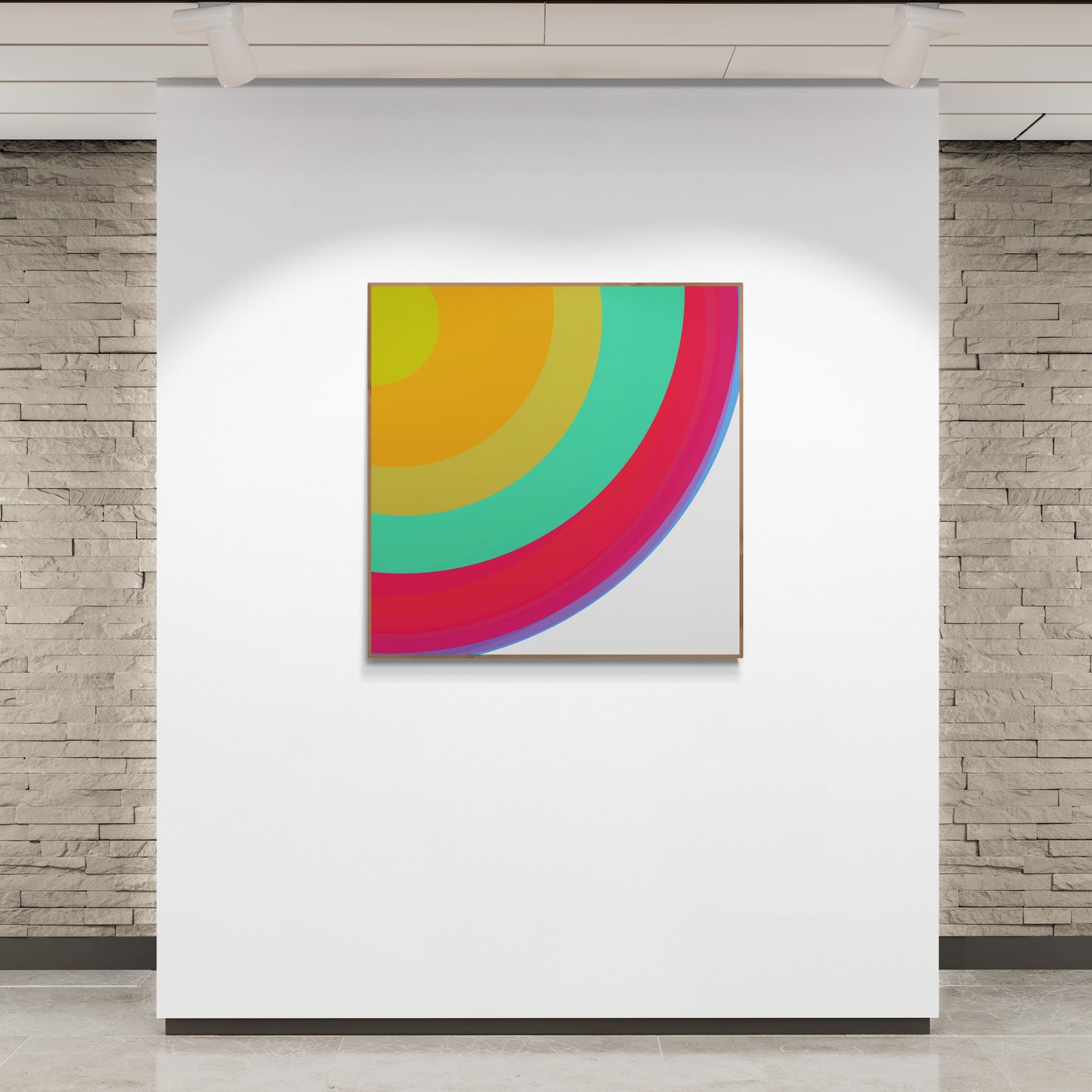 Colorful abstract art print on a white wall with stone walls in the background