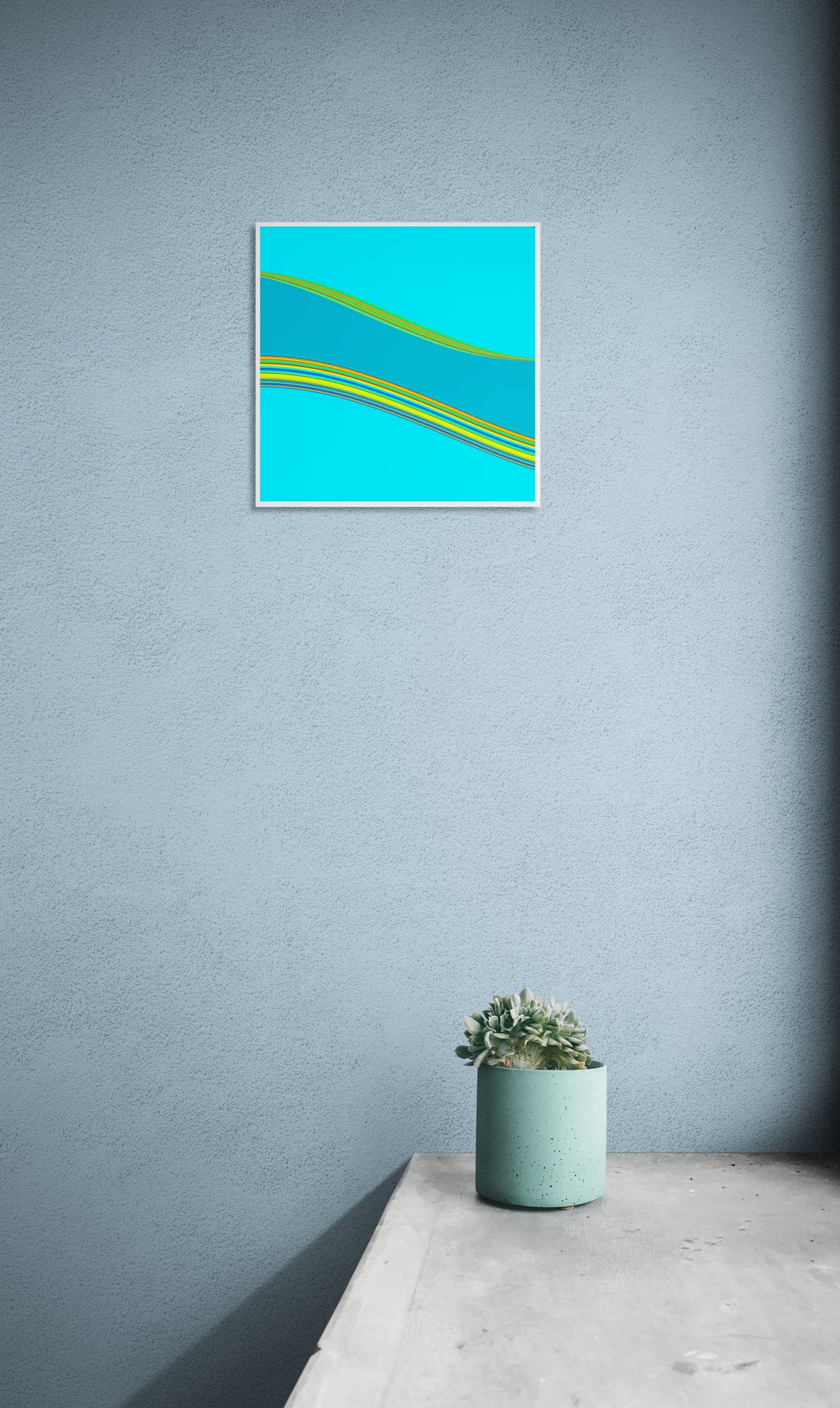 Abstract generative art print with blue and green colors on a gray wall above a white surface with a plant.