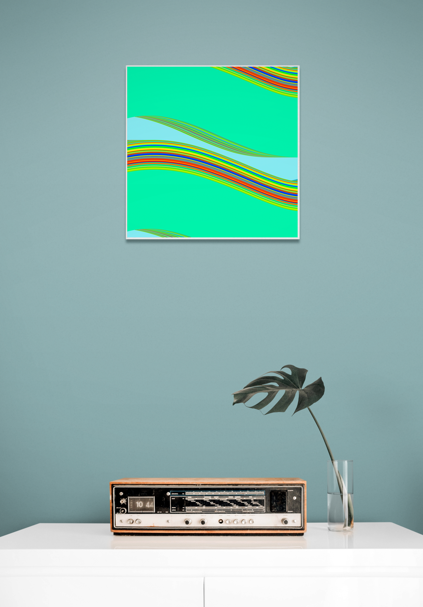 Abstract generative art print with colorful stripes on a teal background, displayed above a vintage radio on a light blue wall.