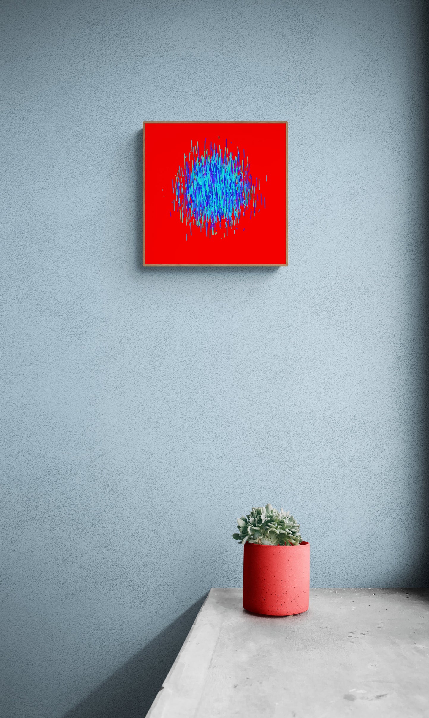 Abstract patterned art print of blue and green lines on a red background on a gray wall, accompanied by a small potted plant.