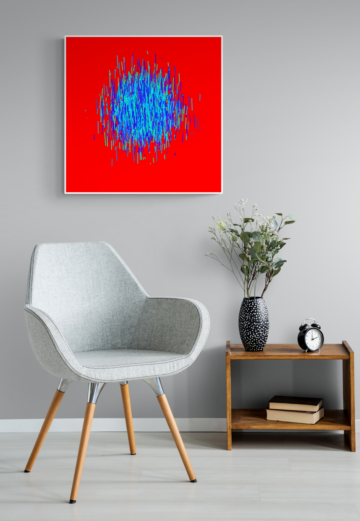 Modern interior with a gray chair, wooden side table, and abstract patterned art print of blue and green lines on a red background.