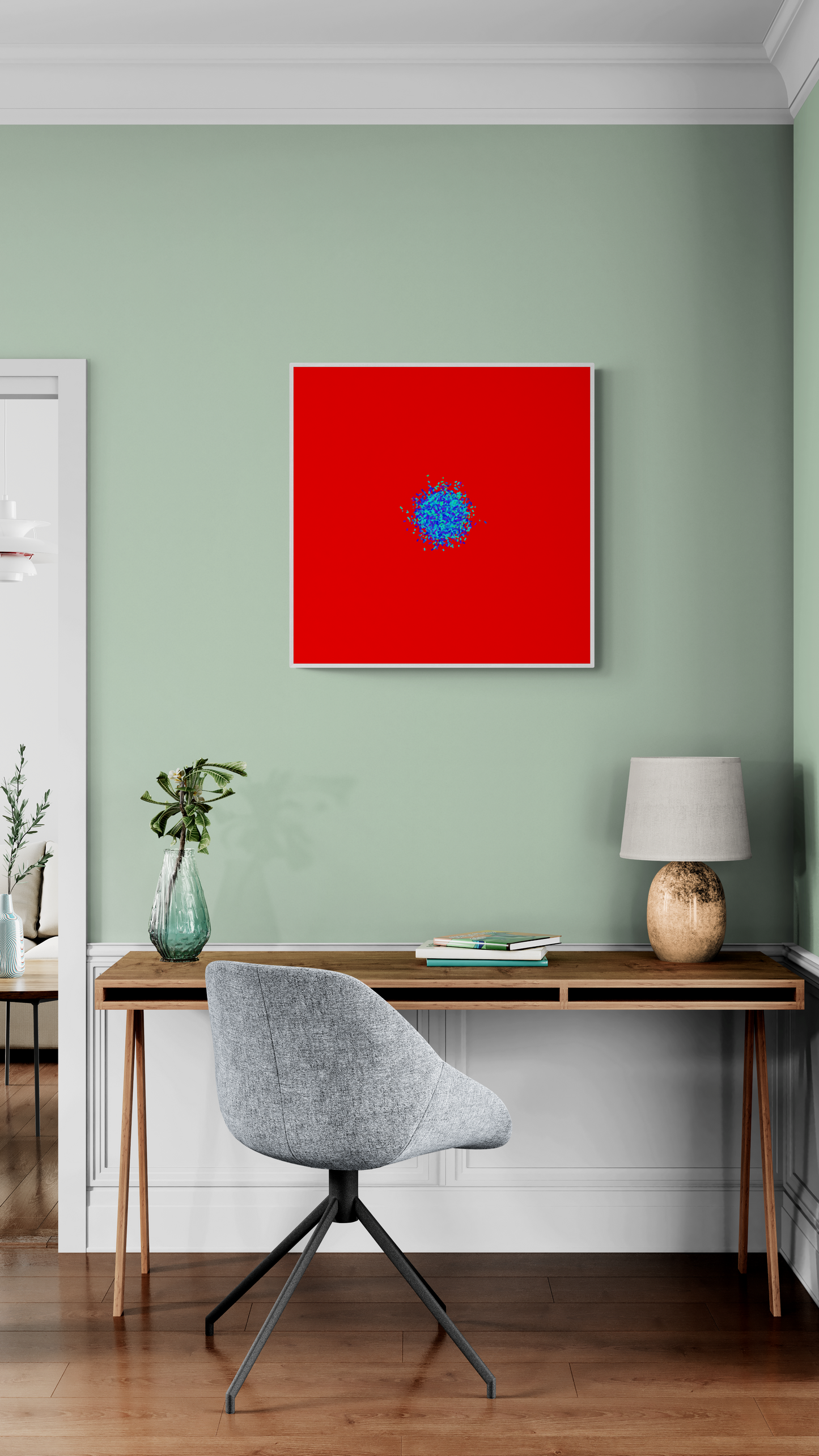Abstract patterned art print of ball of blue and green fragments on a red background on a green wall, a desk, and chair.