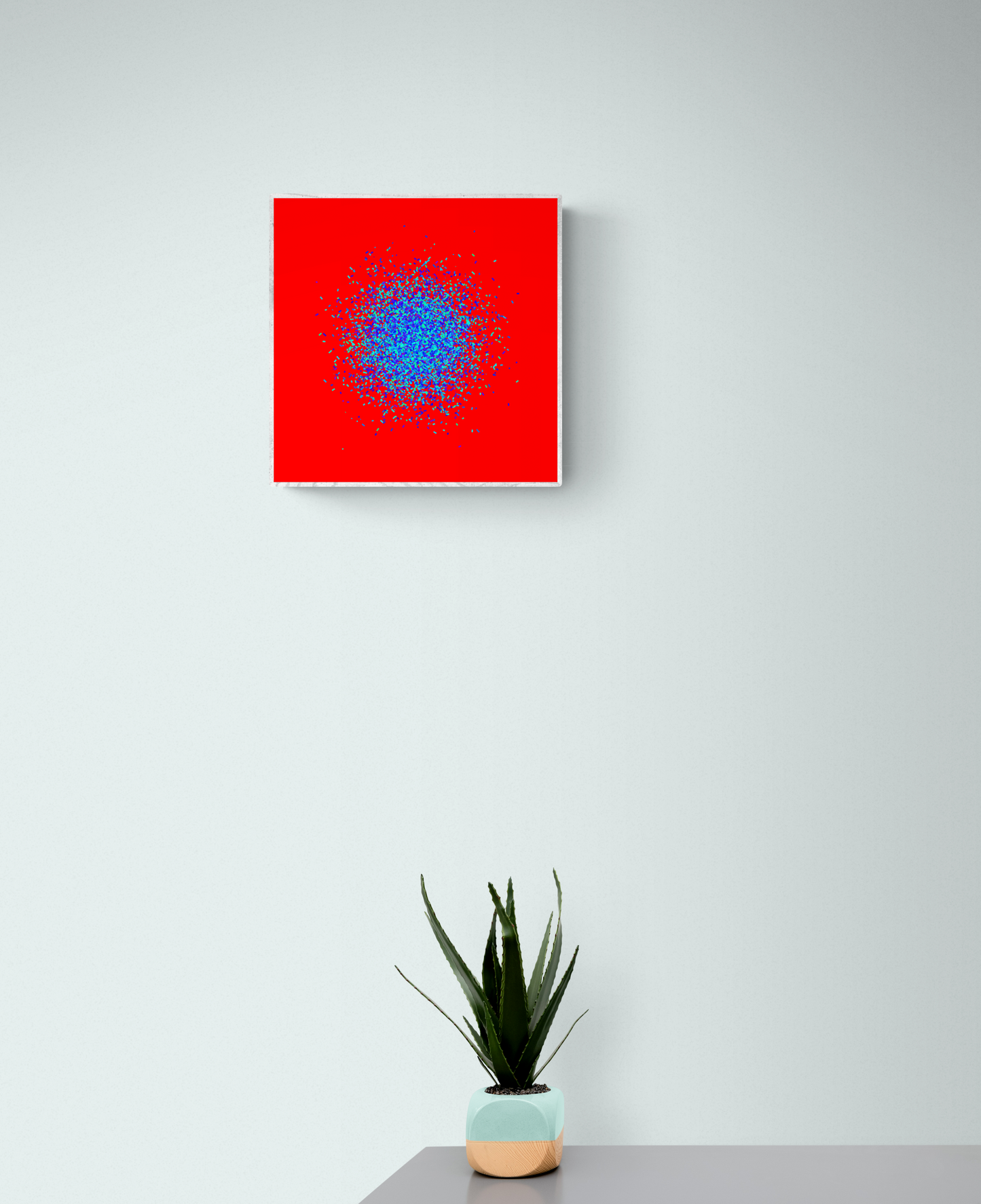 Abstract circle patterned art print of blue and green fragments on a red background, placed above a potted plant on a table.
