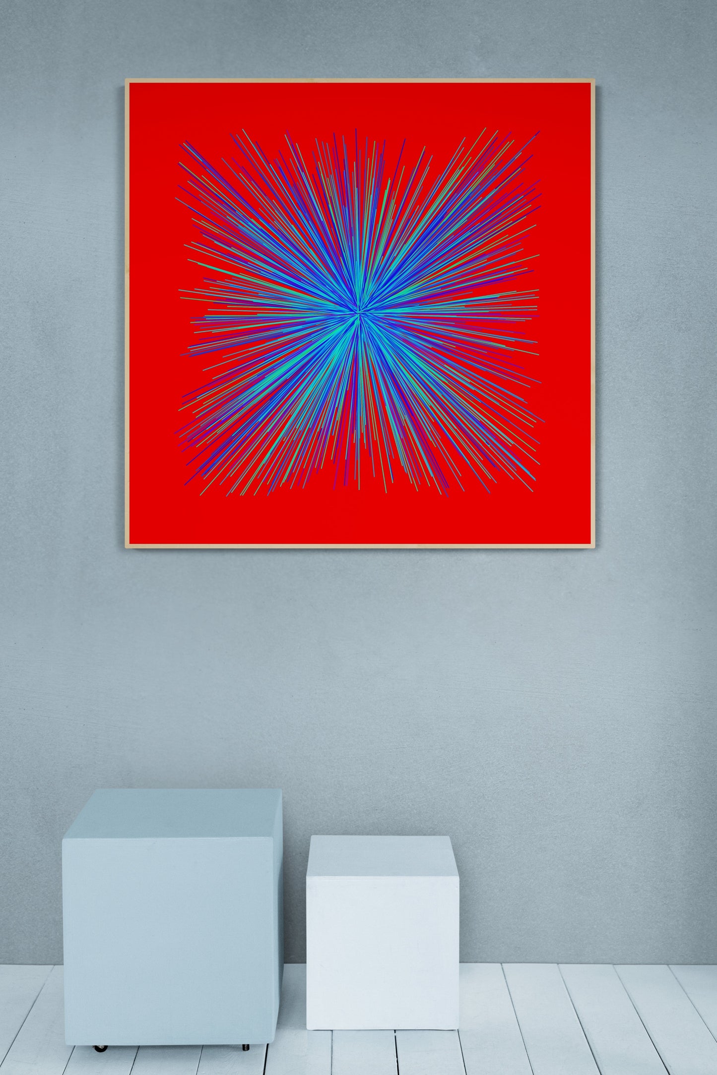 Abstract art print of colorful blue, green radialburst pattern on a red background, framed and hanging on a gray wall.