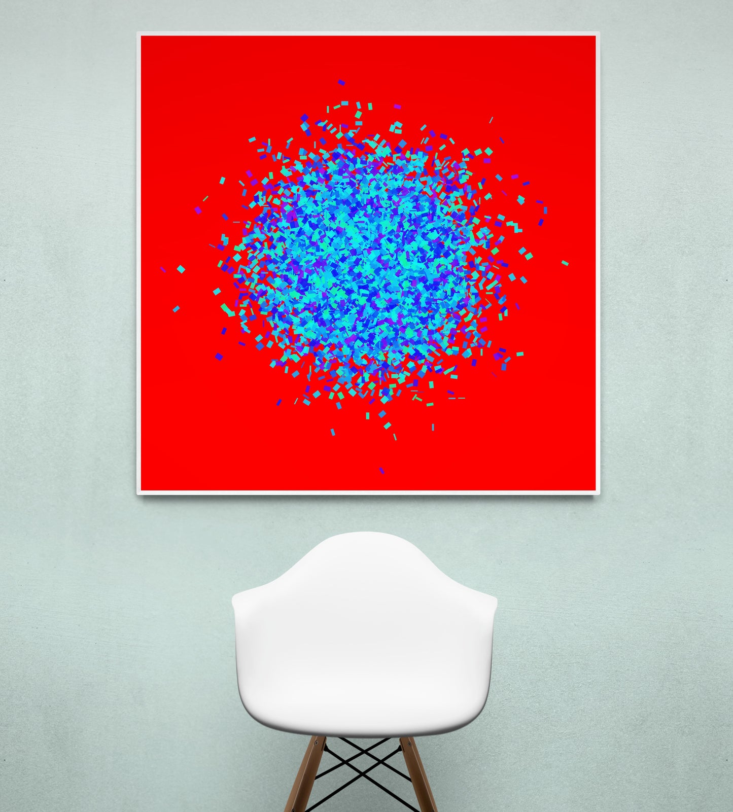 Blue, green, purple confetti like patterned abstract print on a red background, displayed on a light gray wall with a white chair.