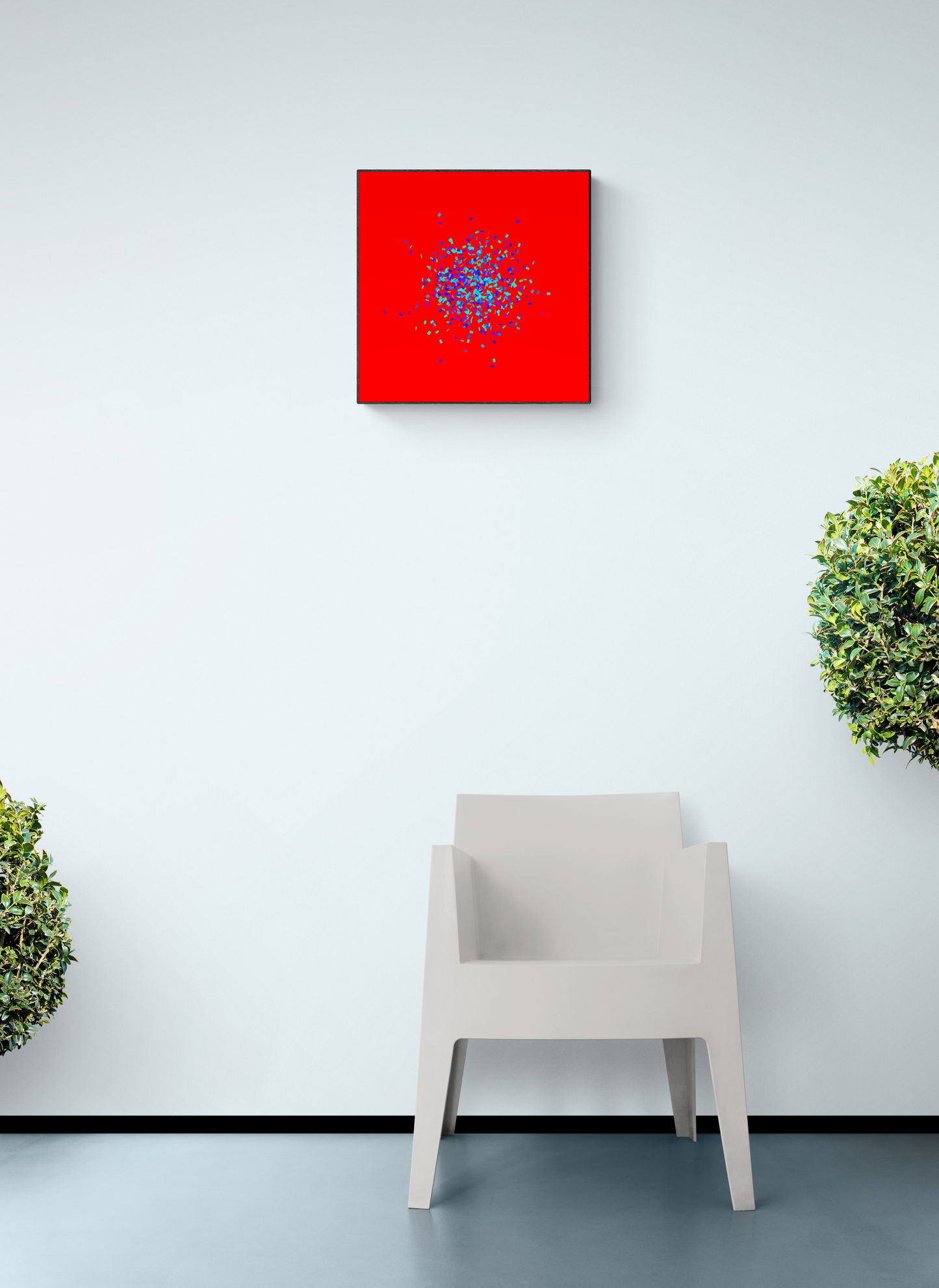 Blue, green, purple confetti like patterned abstract print on a red background above a white chair with plants on either side.