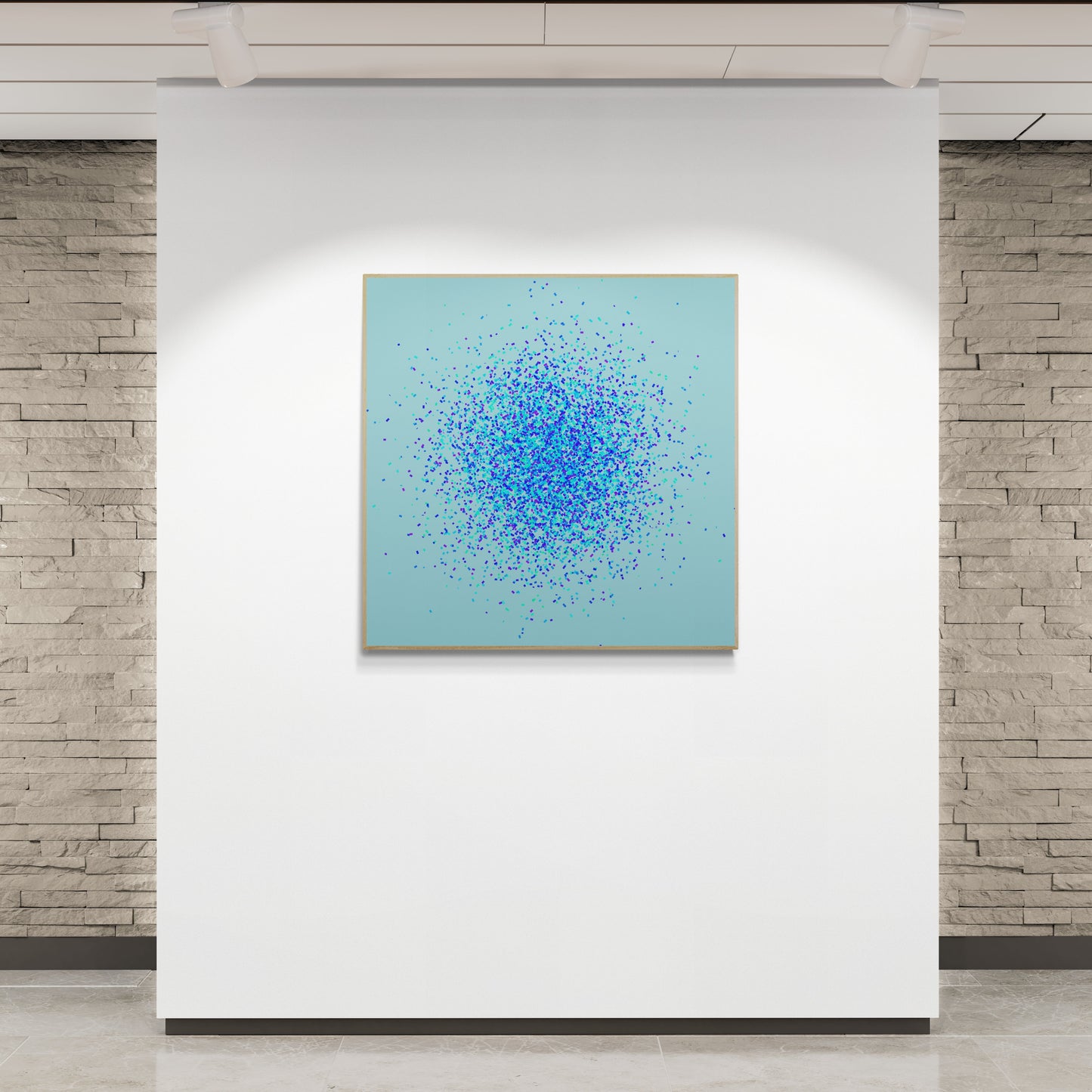 Abstract art print of blue, green and purple confetti like circular pattern on a light blue background in an indoor gallery setting.