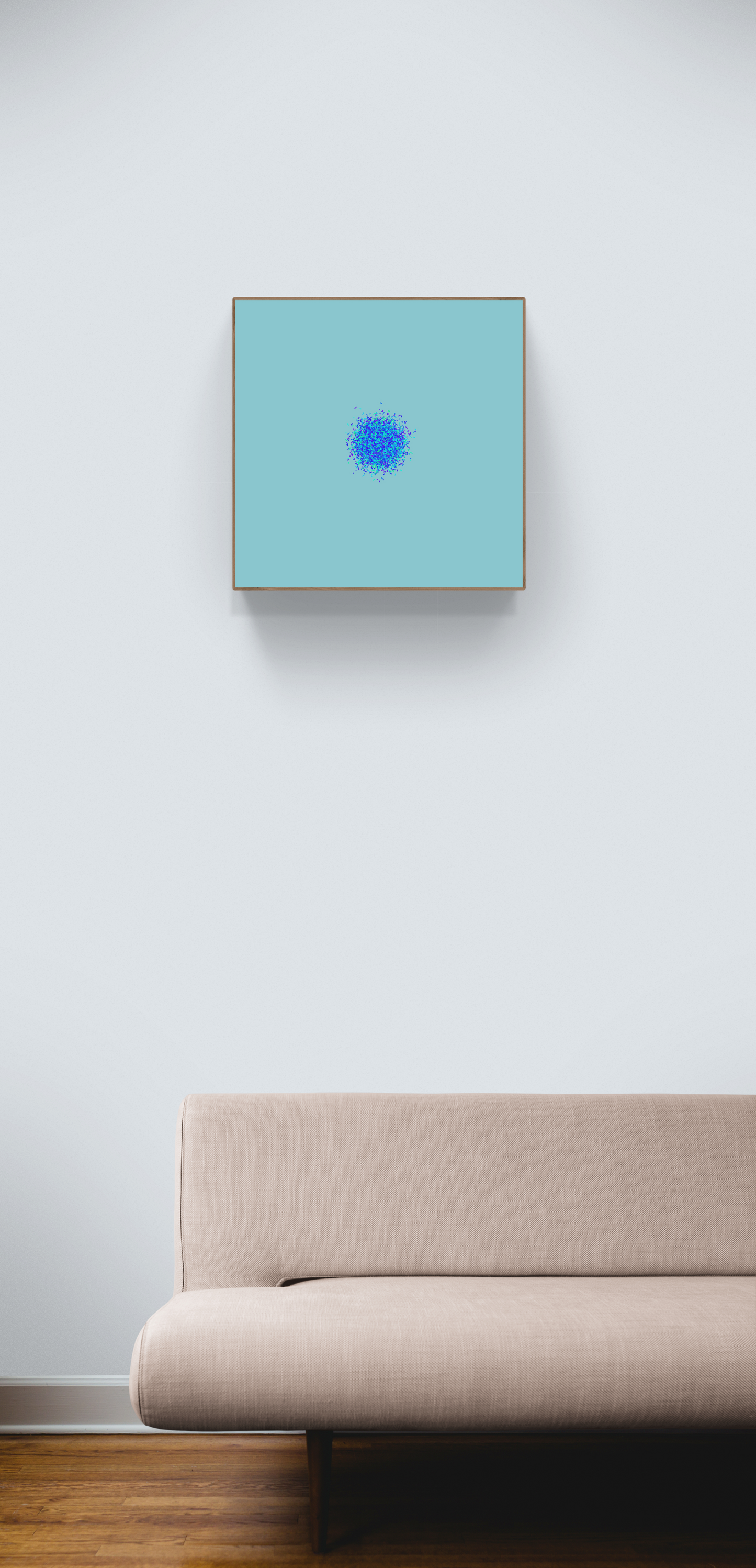 Sofa in a room with an abstract art print of blue, green and purple confetti like circular pattern on a light blue background on the wall.