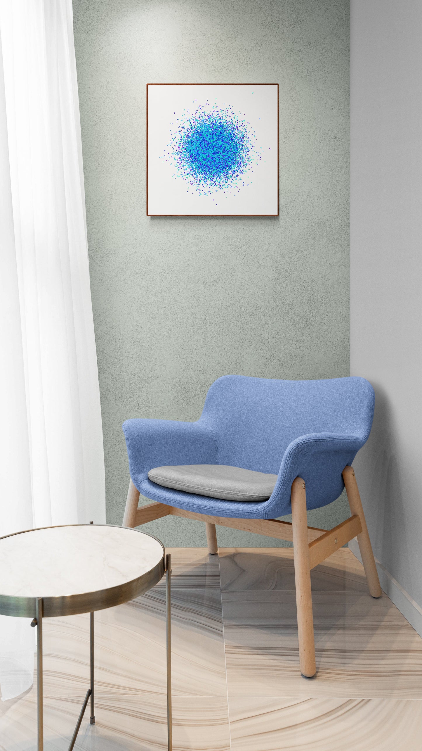 Blue chair with a round table against a gray wall with a blue, gree abstract print.