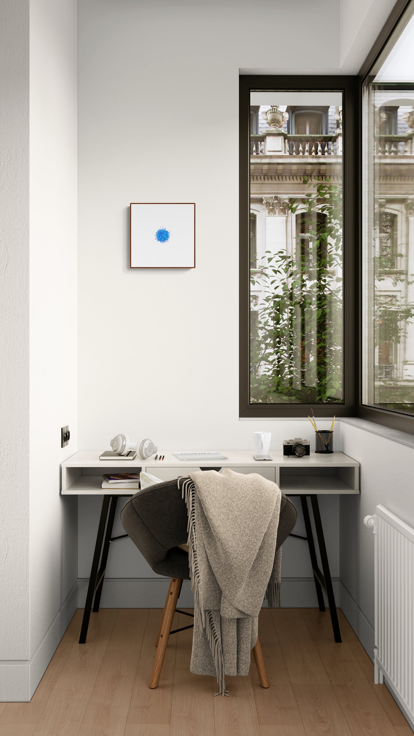 Modern home office with a desk, chair, and blue and green colour particle like circle abstract art print on a white background on a white wall.