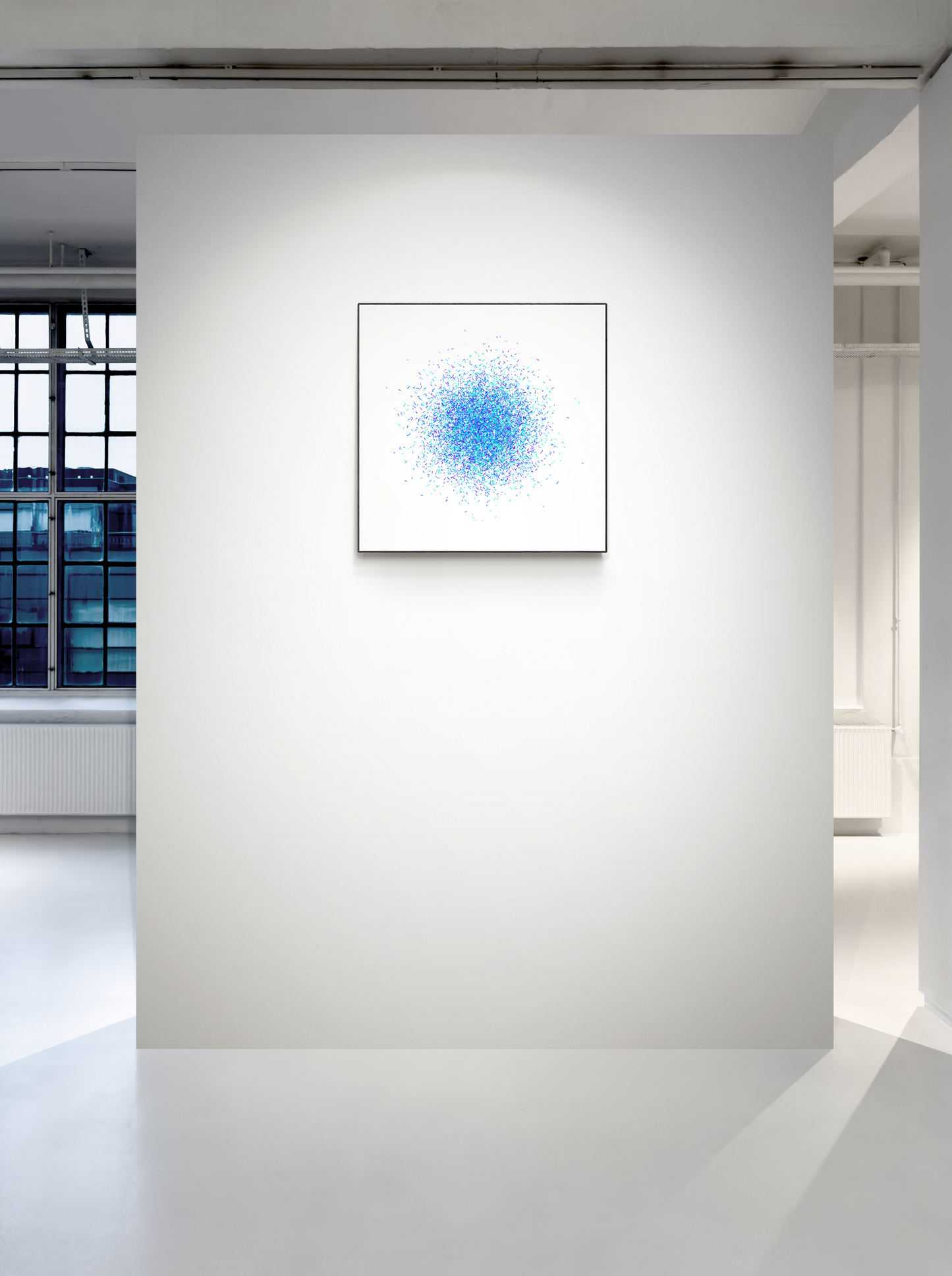 Framed abstract art print with blue and white design on a white wall.