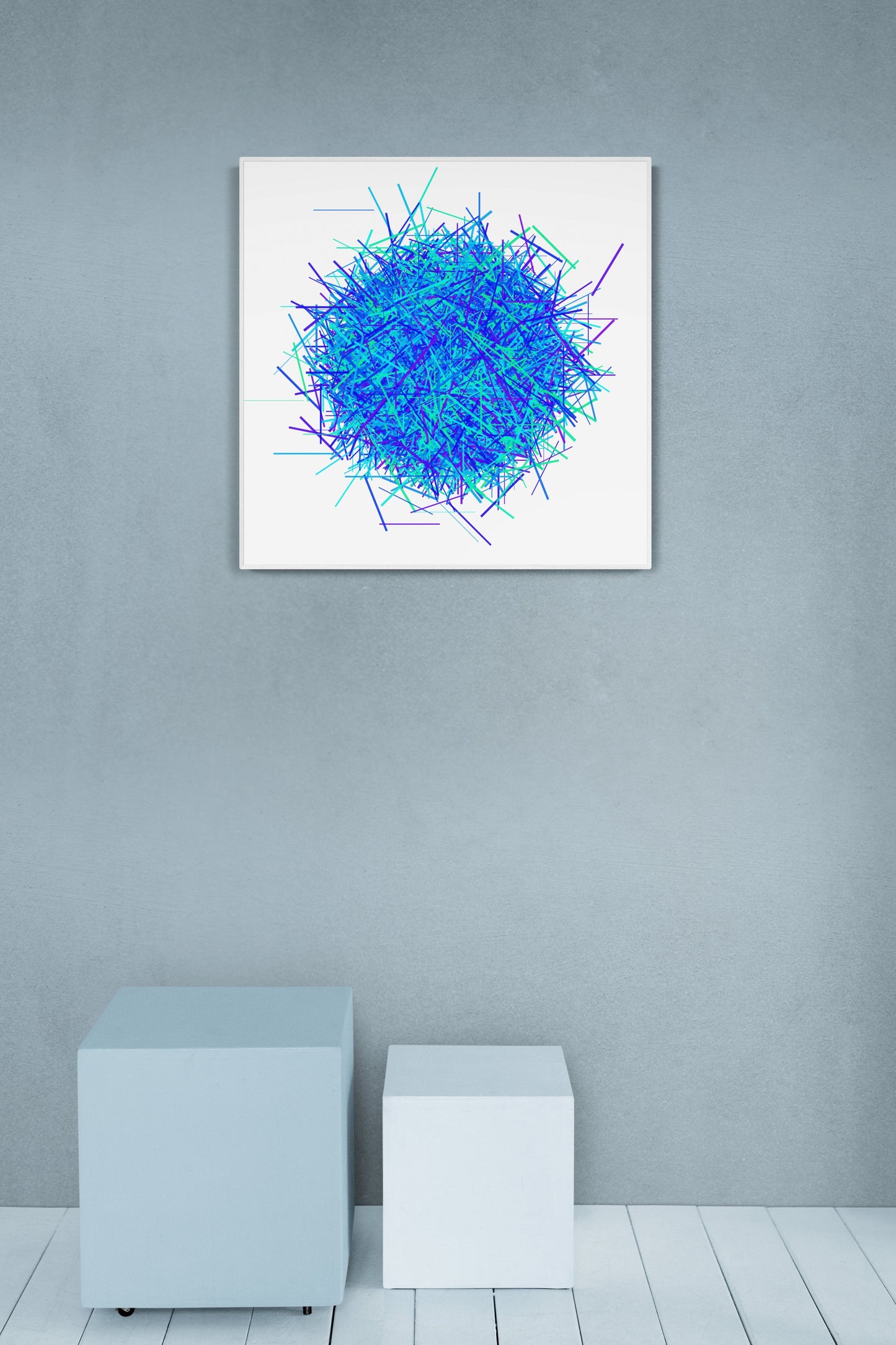 Abstract patterned print of intersecting blue, green and purple lines on a white background on a gray wall with furniture below.