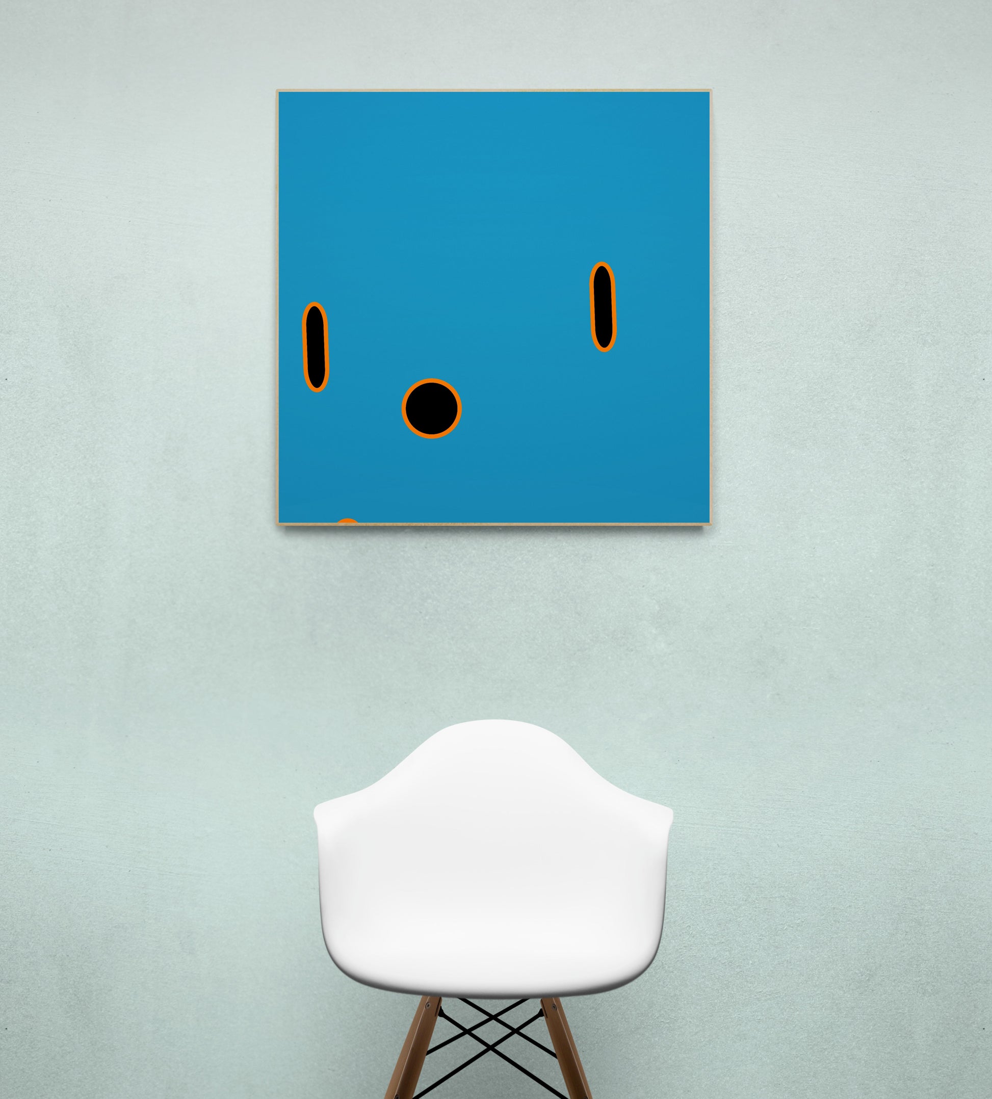 Abstract blue print with black circles on a wall above a white stool.