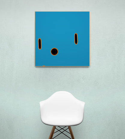 Abstract blue print with black circles on a wall above a white stool.