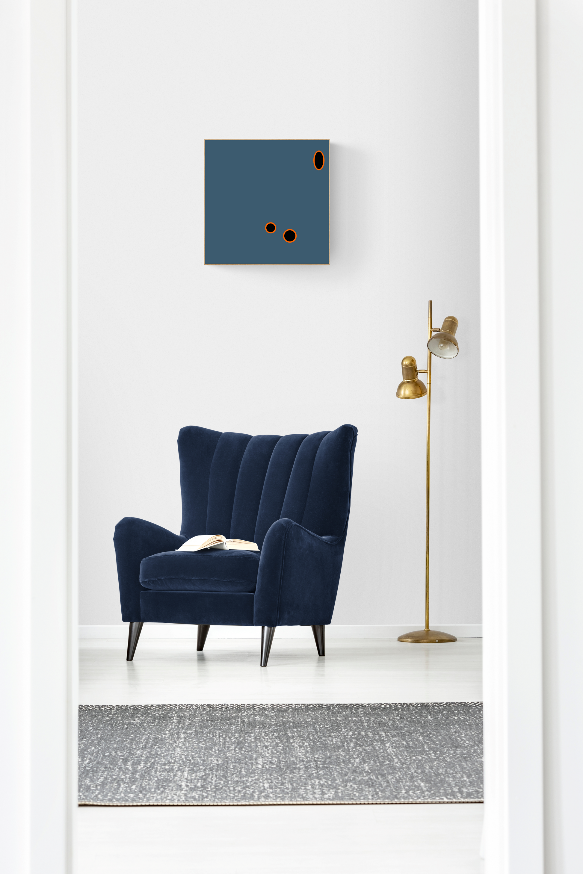 Navy blue armchair in a minimalistic room with a grey abstract wall art print and floor lamp.