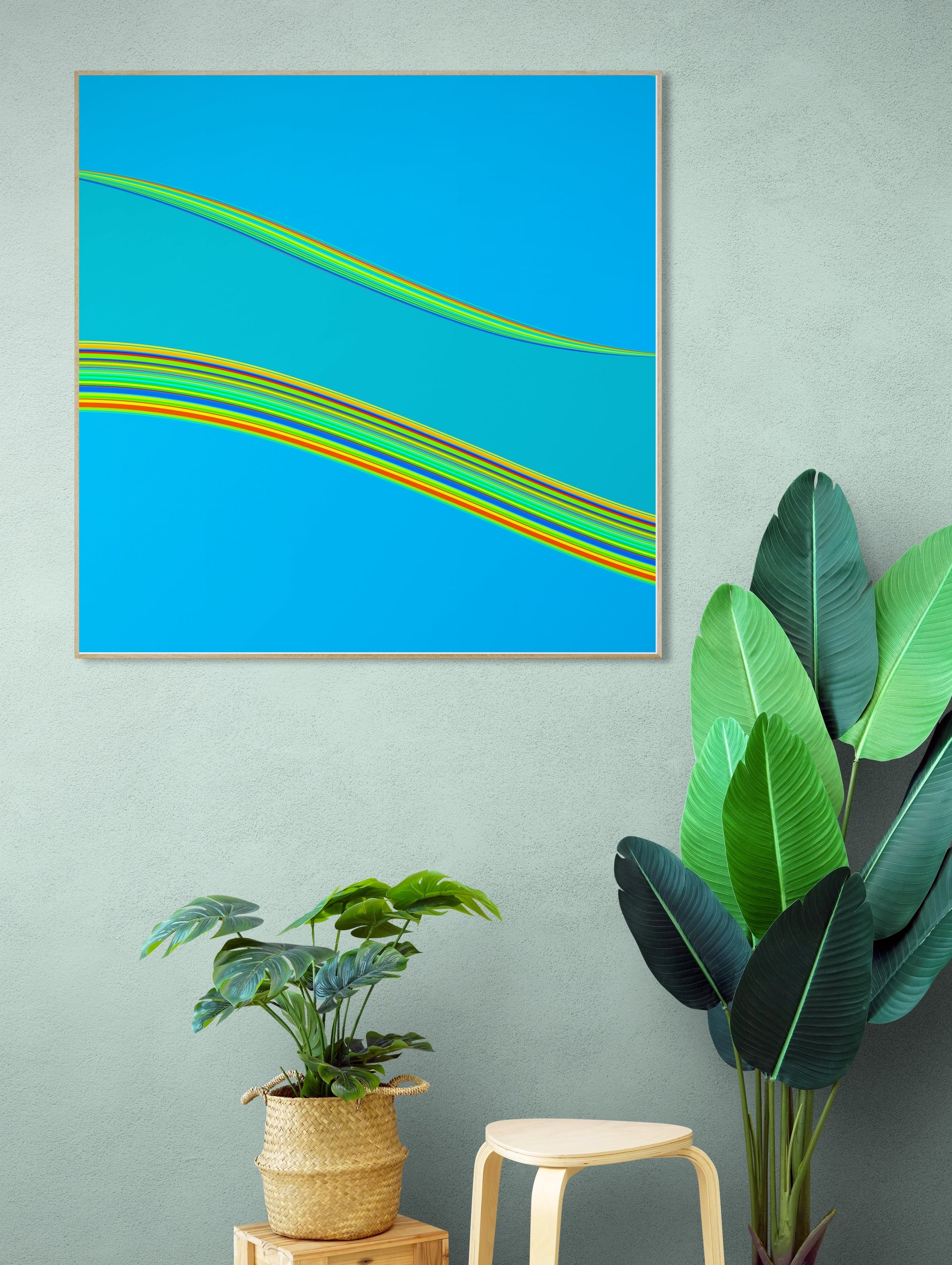 Abstract generative art print with colorful lines on a blue background, displayed on a wall with plants below.