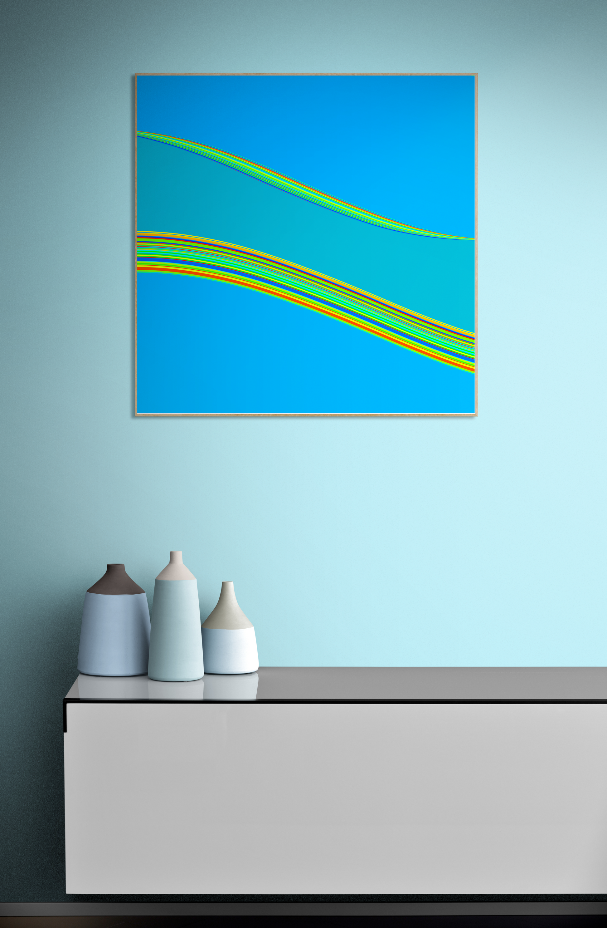 Abstract generative art print with blue and green colors on a light blue wall above a white cabinet with decorative bottles.
