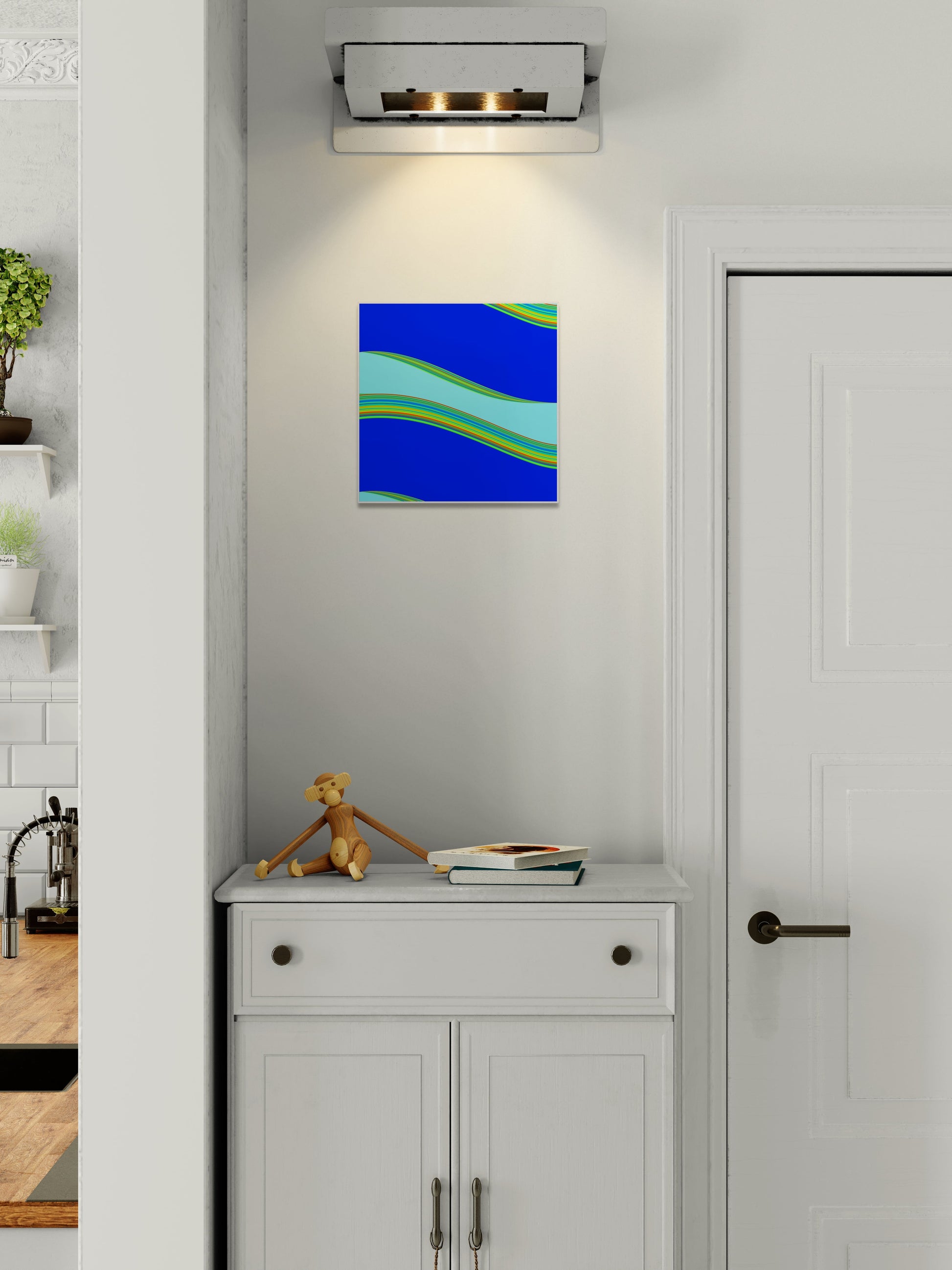 Abstract generative art print on a wall above a cabinet with a small figurine and book.