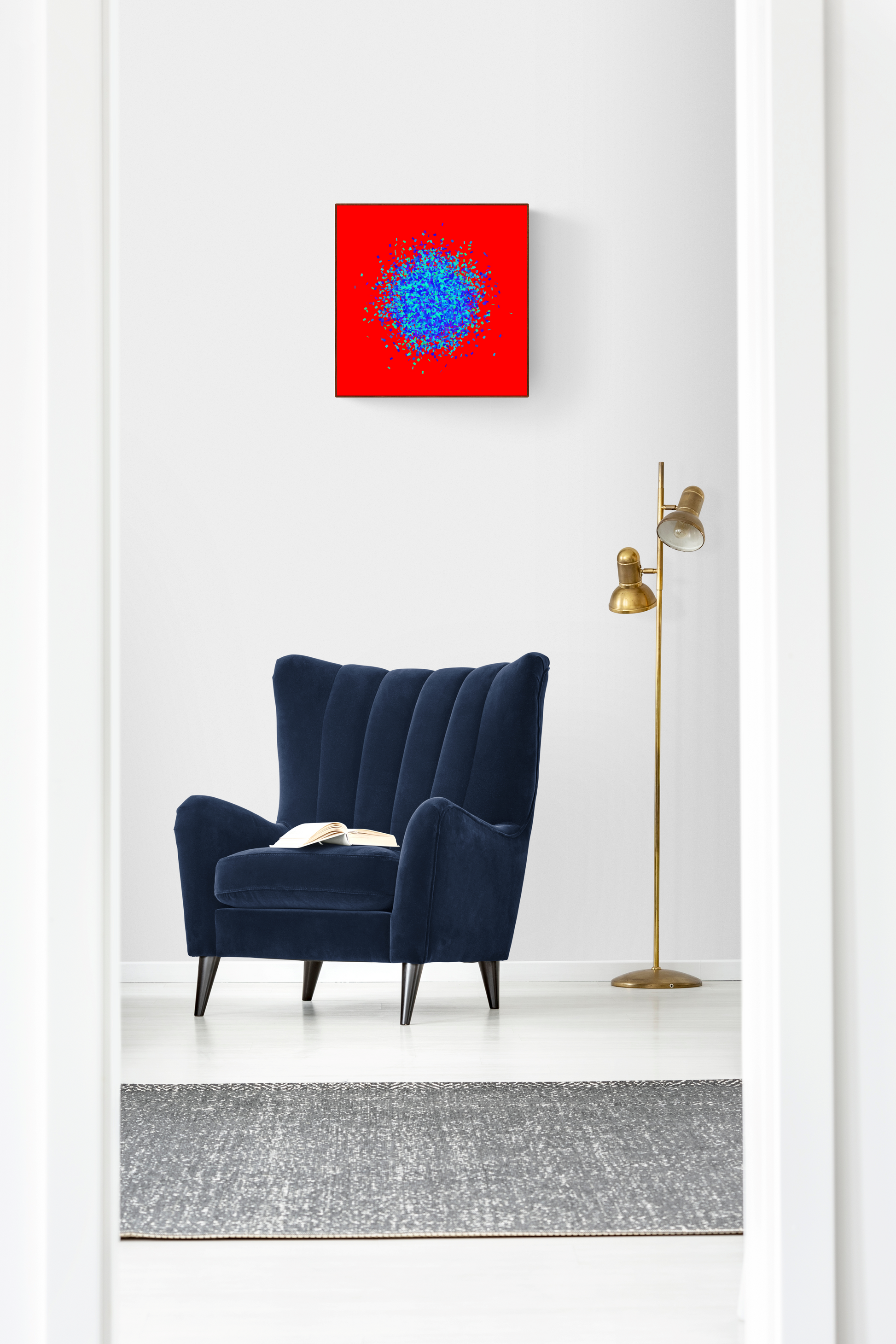 Navy blue armchair in a room with a blue, green, purple confetti like patterned abstract print on a red background on the wall.