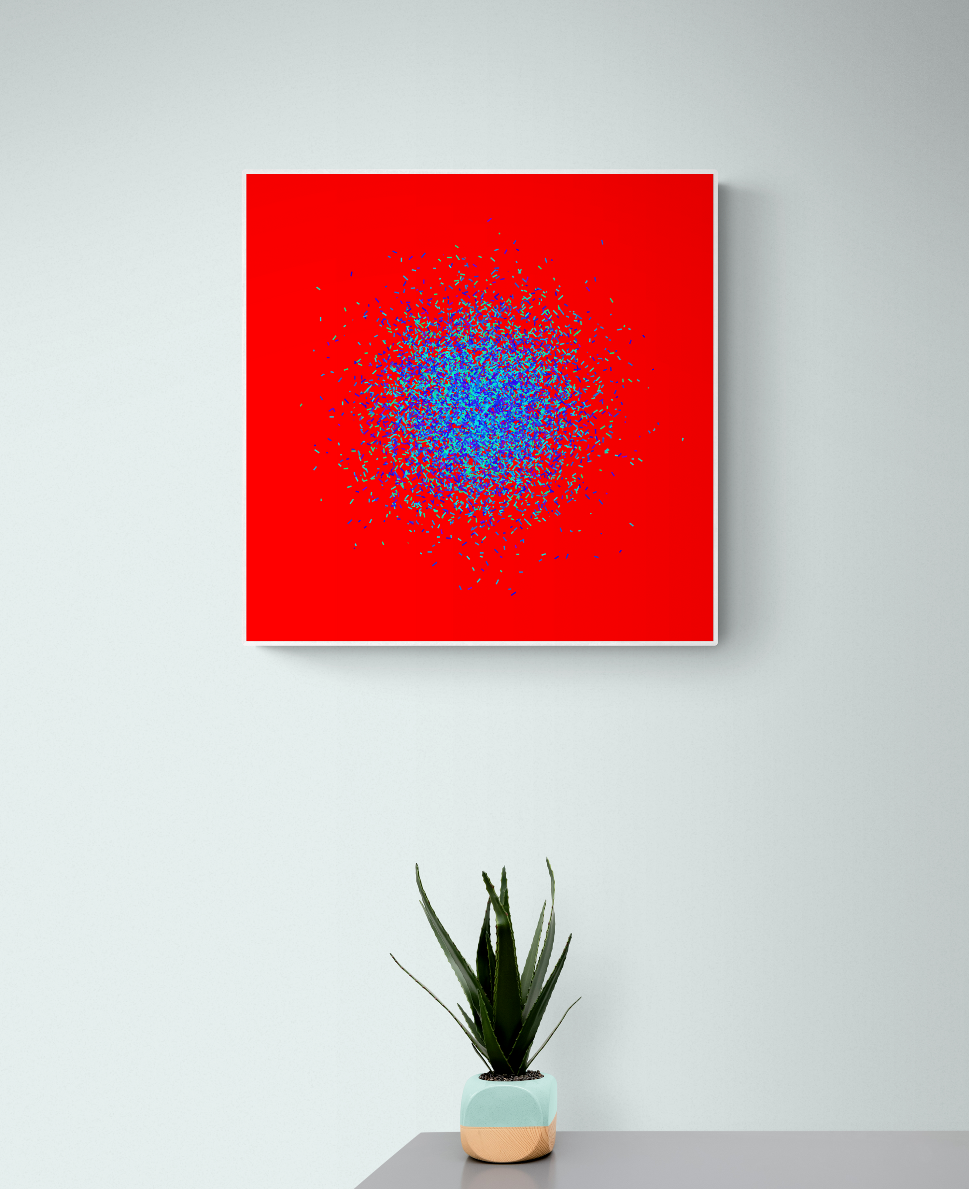 Blue, green, purple confetti like patterned abstract art print on a red background, displayed on a gray wall with a plant below.