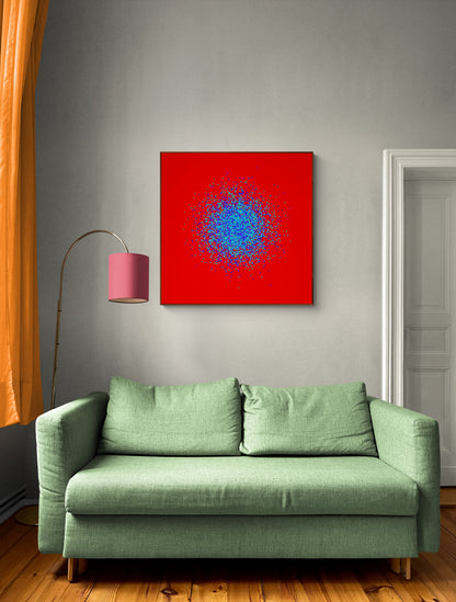 Green sofa in a room with a blue, green, purple confetti like patterned abstract print on a red background on the wall.