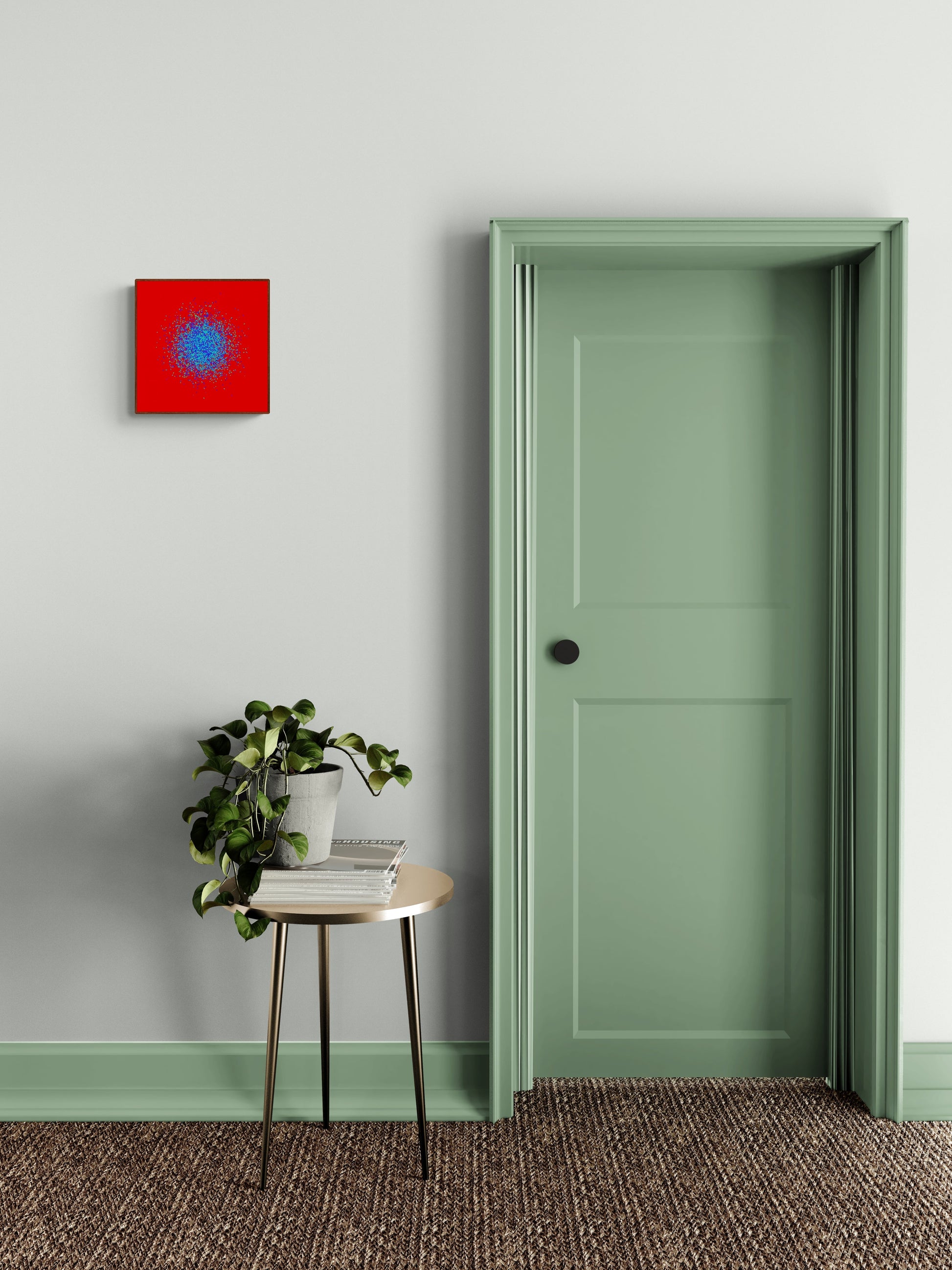 Room interior with a green door, small table with plant, and blue, green, purple confetti like patterned abstract print on a red background on gray wall.