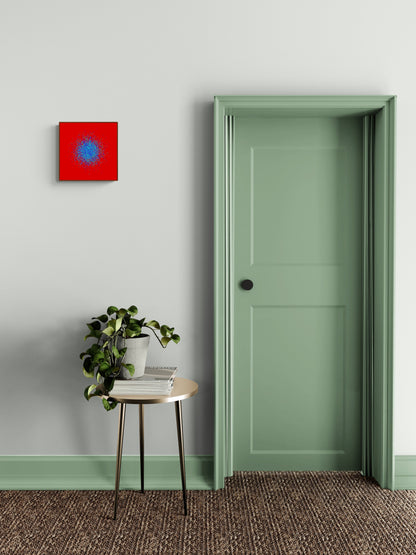 Room interior with a green door, small table with plant, and blue, green, purple confetti like patterned abstract print on a red background on gray wall.