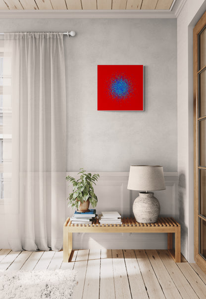 Modern interior with a blue, green, purple confetti like patterned abstract print on a red background on a white wall, wooden bench, and lamp.