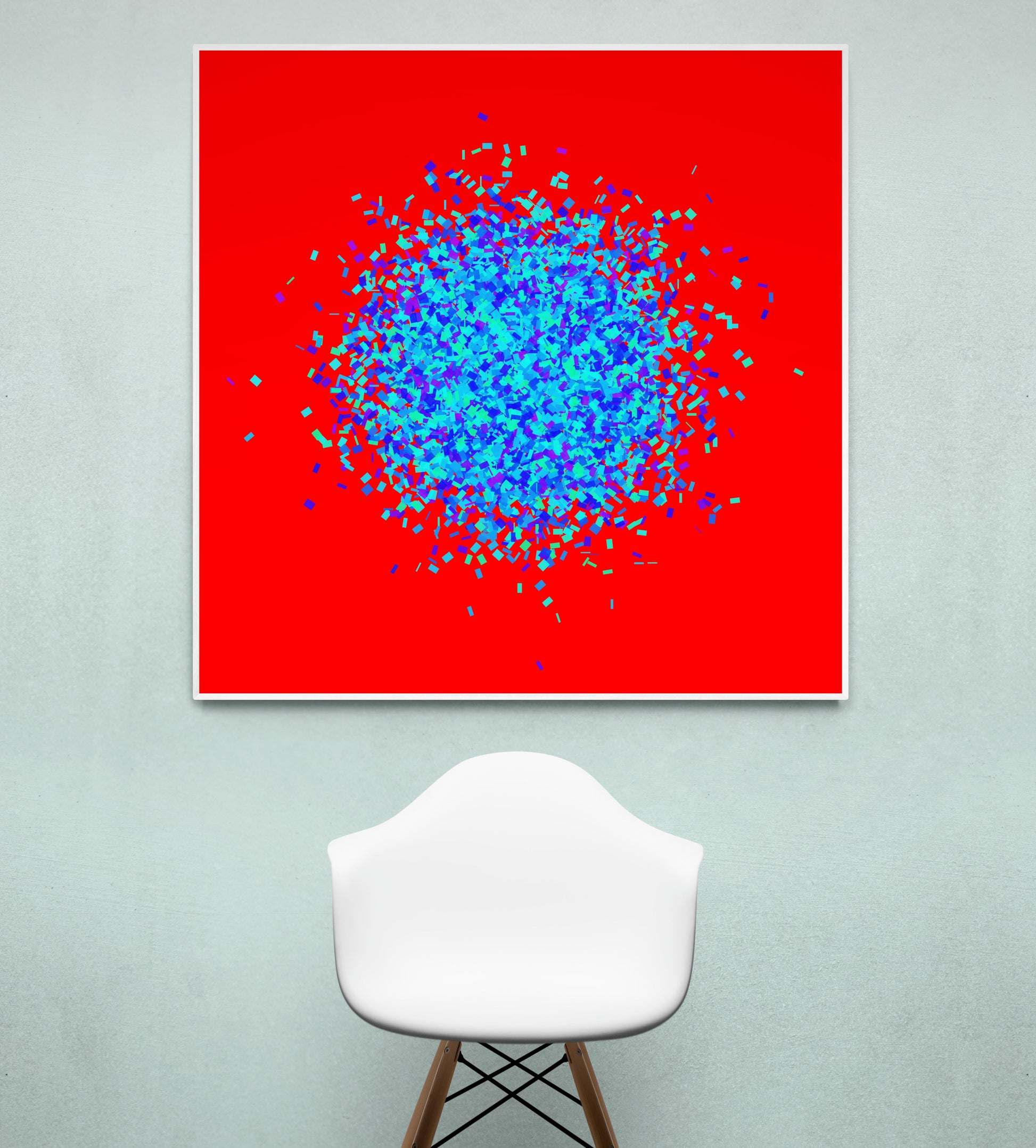 Blue, green, purple confetti like patterned abstract print on a red background, displayed on a light gray wall with a white chair.