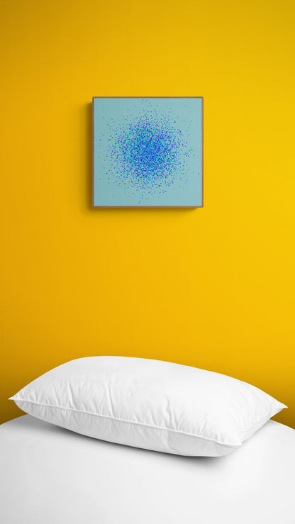 Abstract art print of blue, green and purple confetti like circular pattern on a light blue background on a yellow wall above a white bed