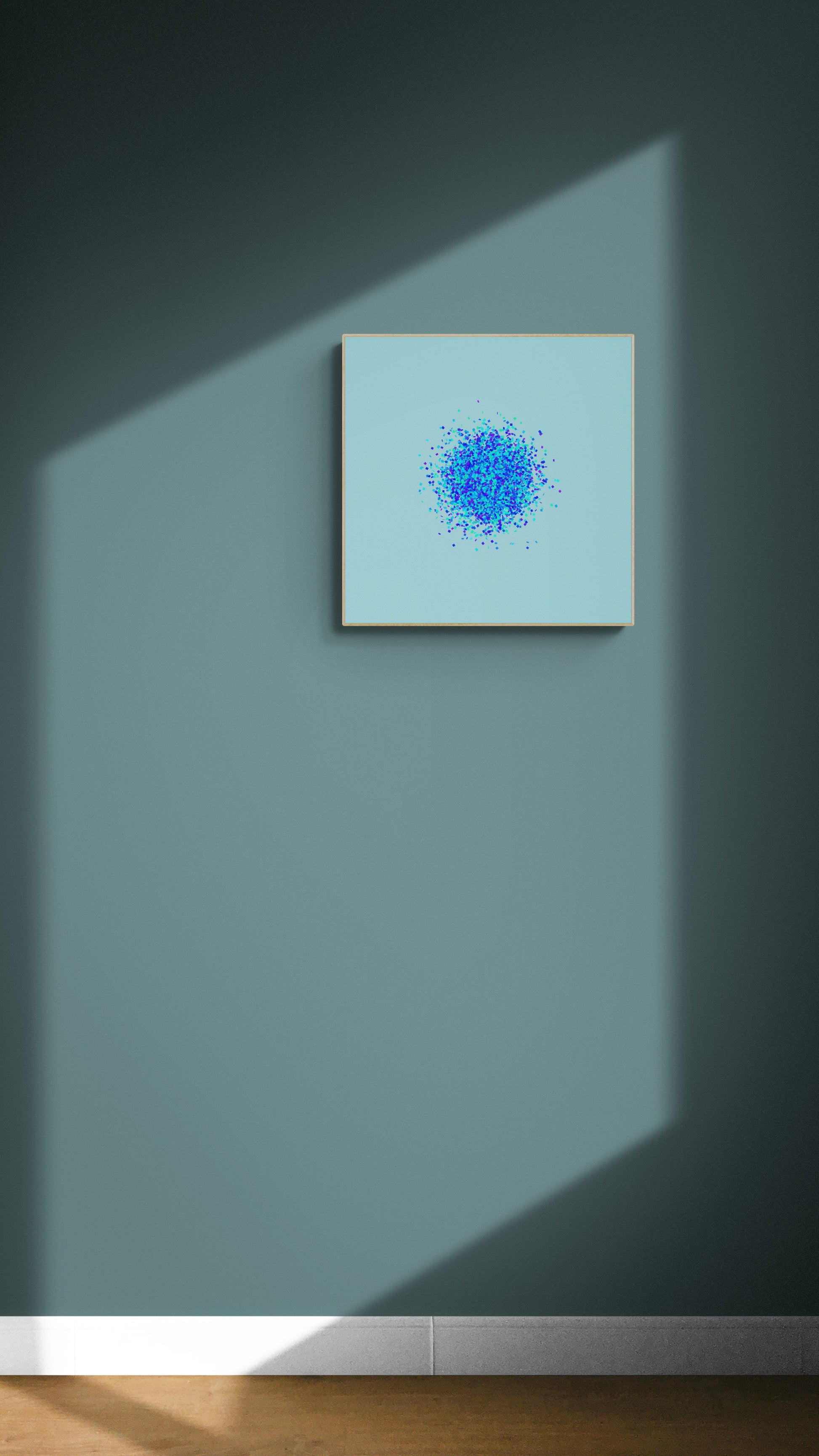 Abstract art print of blue, green and purple confetti like circular pattern on a light blue background on a gray wall