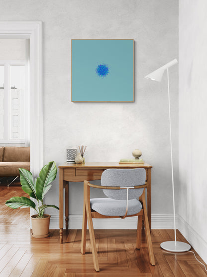 Modern home office with wooden desk, chair, and abstract art print of blue, green and purple confetti like circular pattern on a light blue background on wall.