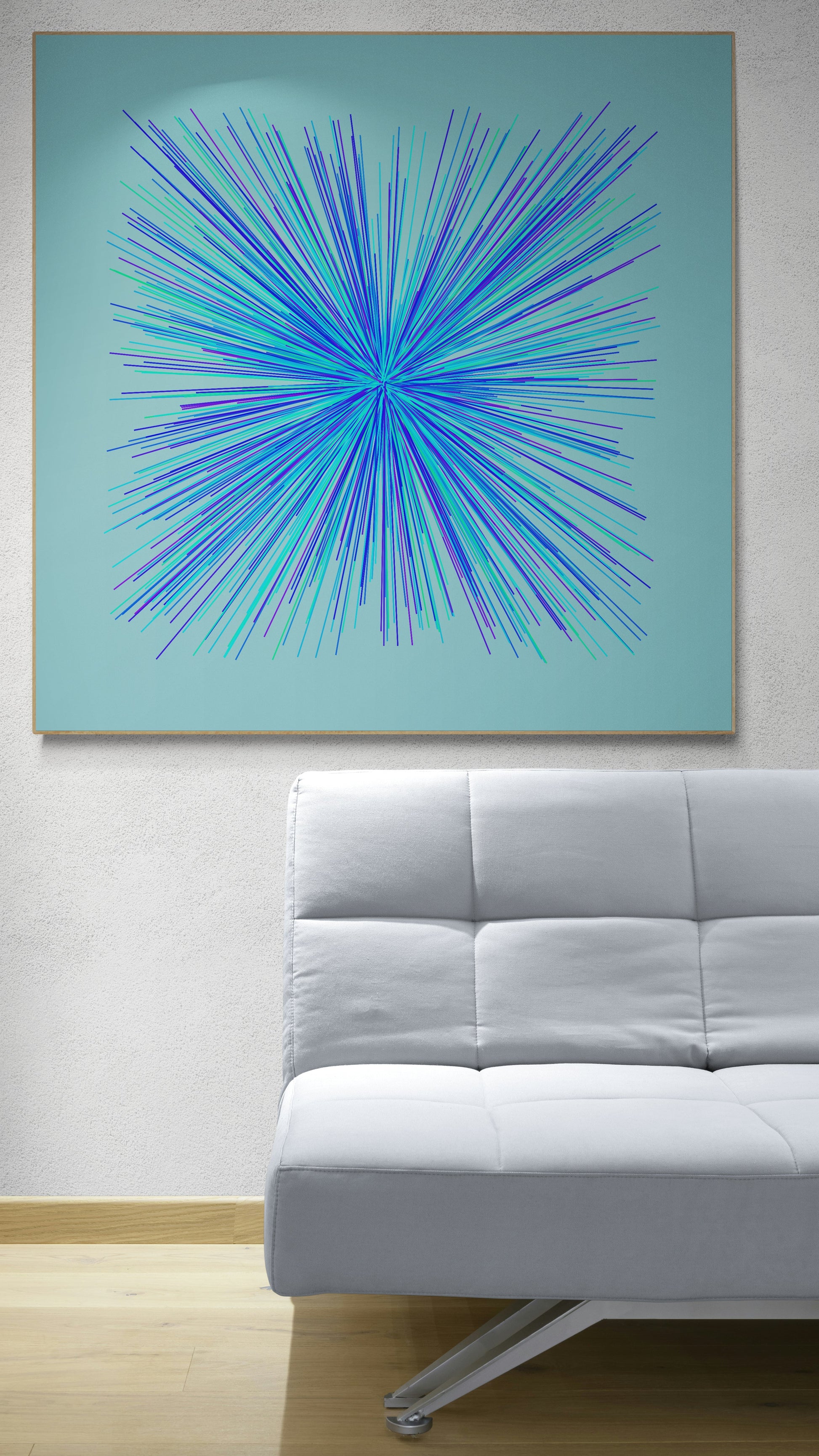 Abstract art print of blue, green and purple lines in a radial burst pattern on a light blue background on a light blue wall above a white sofa.