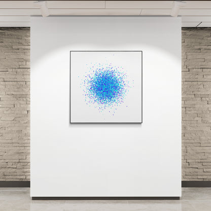 Framed abstract artwork print with blue and white pattern on a white wall.