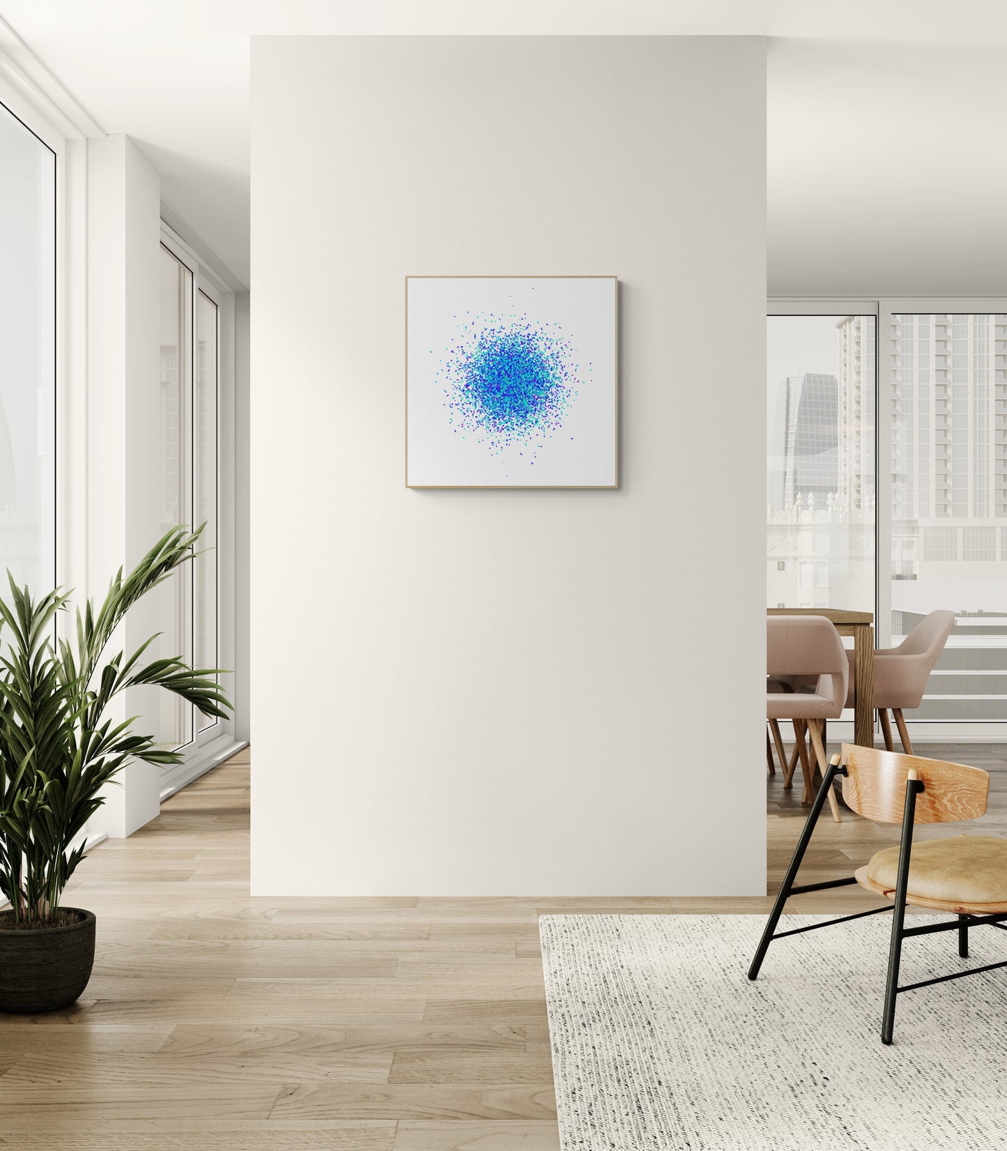 Modern interior with a blue and green speckle patterned abstract art print on a white background on a white wall, a plant, and a chair.