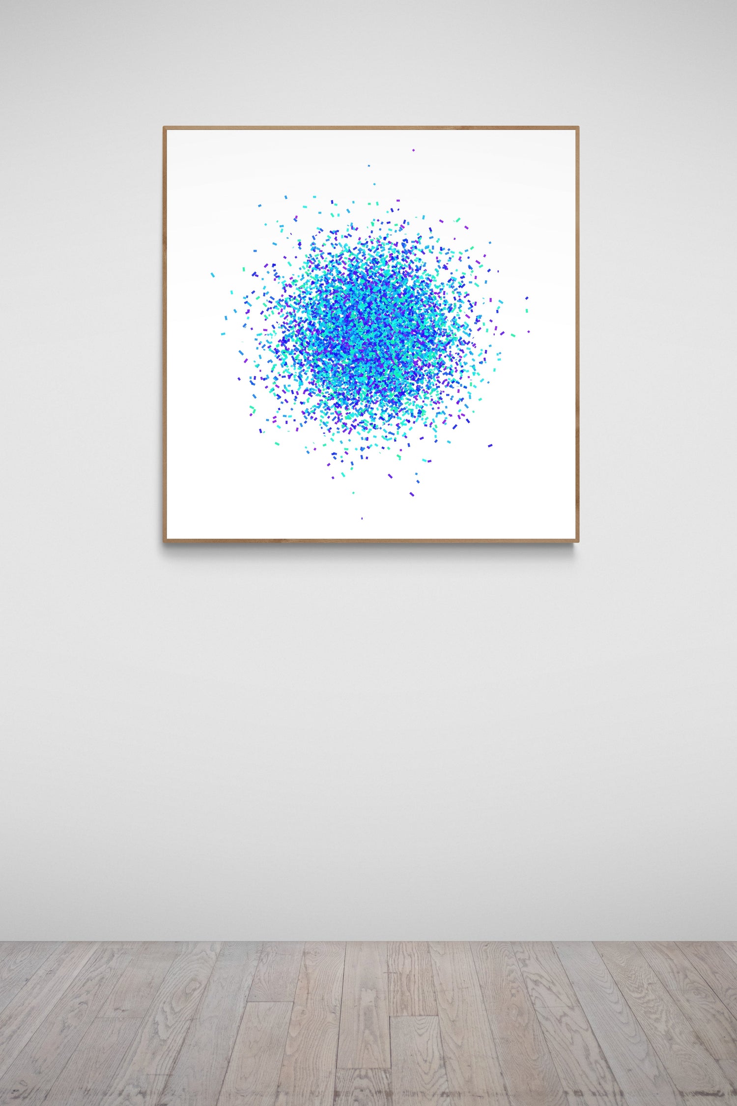 Blue and green confetti like patterned abstract print on a white background on a white wall.